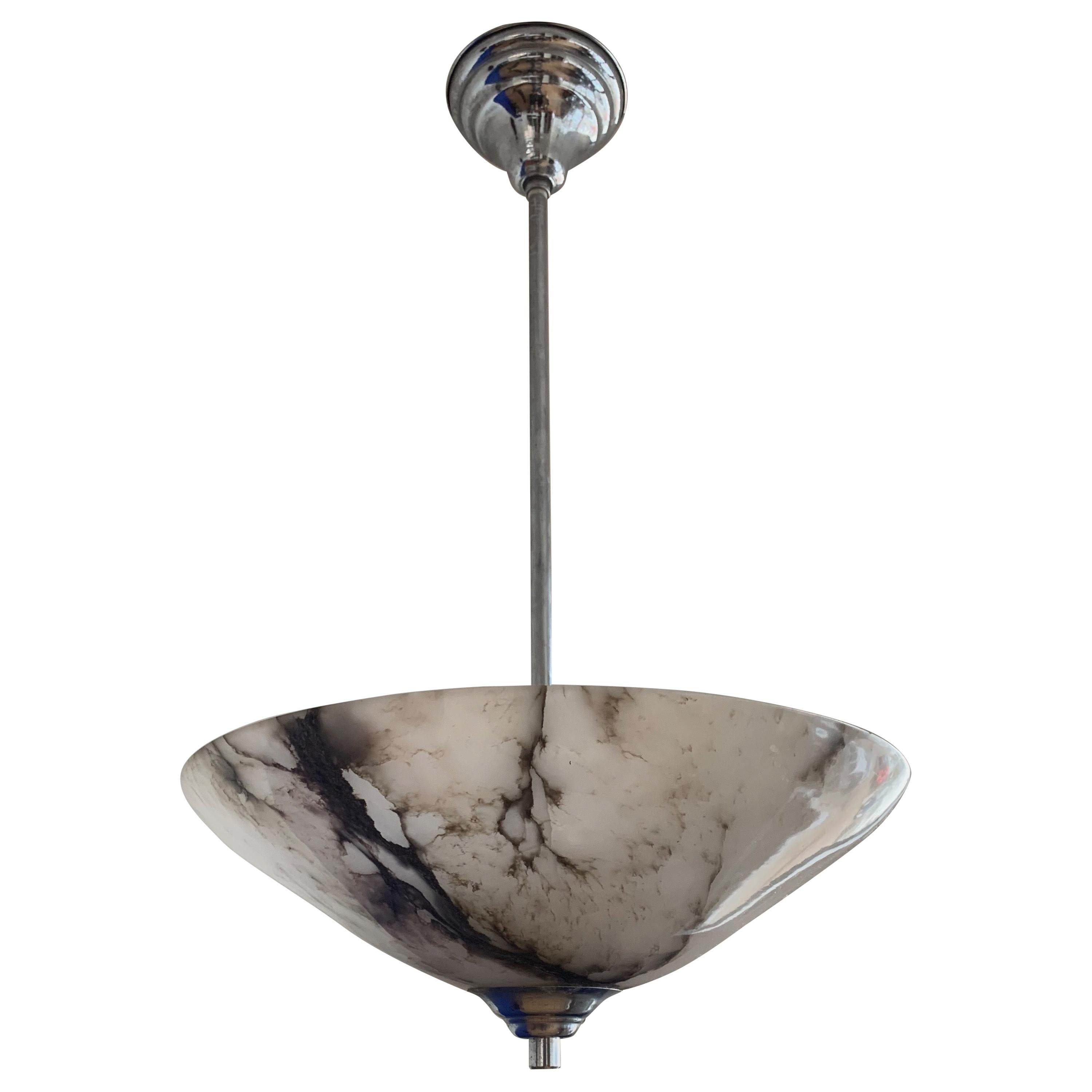 Timeless and very good condition alabaster light fixture.

This wonderfully designed and truly beautiful light fixture has been very well looked after by its former owners. This great design, single antique alabaster shade with chrome hardware is