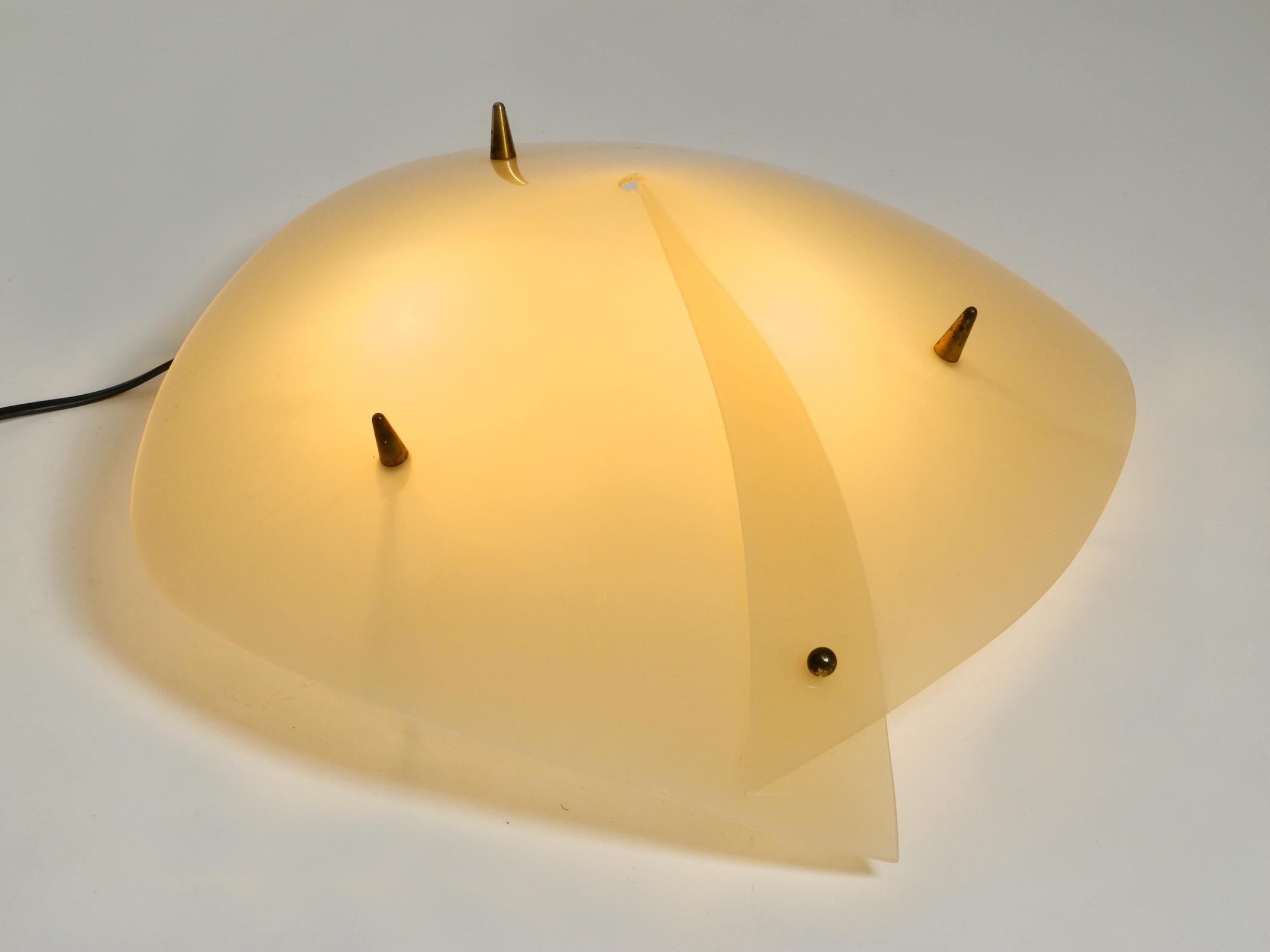 Beautiful and rare Mid-Century Modern plexiglass ceiling lamp.
Great interesting 1950s design.
Shade is made entirely of plexiglass, screwed together with three original tapered screws.
Two original brass E27 sockets.
100% original condition. In