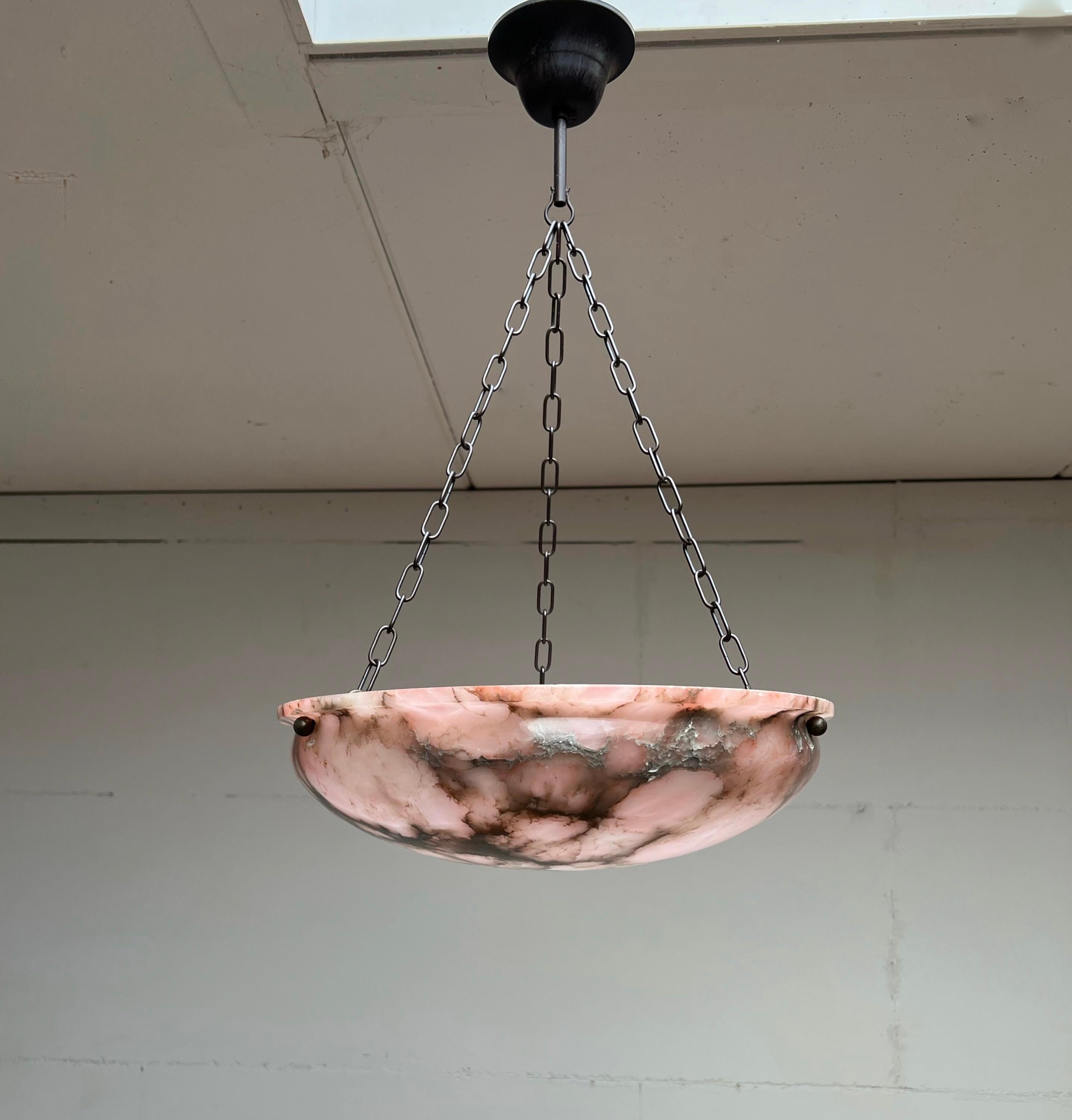Top quality fixture with a stunning alabaster shade and chain / canopy.

Thanks to its unique design and good size this alabaster chandelier will light up both your days and evenings. The stunning original shade is made complete with a blackened