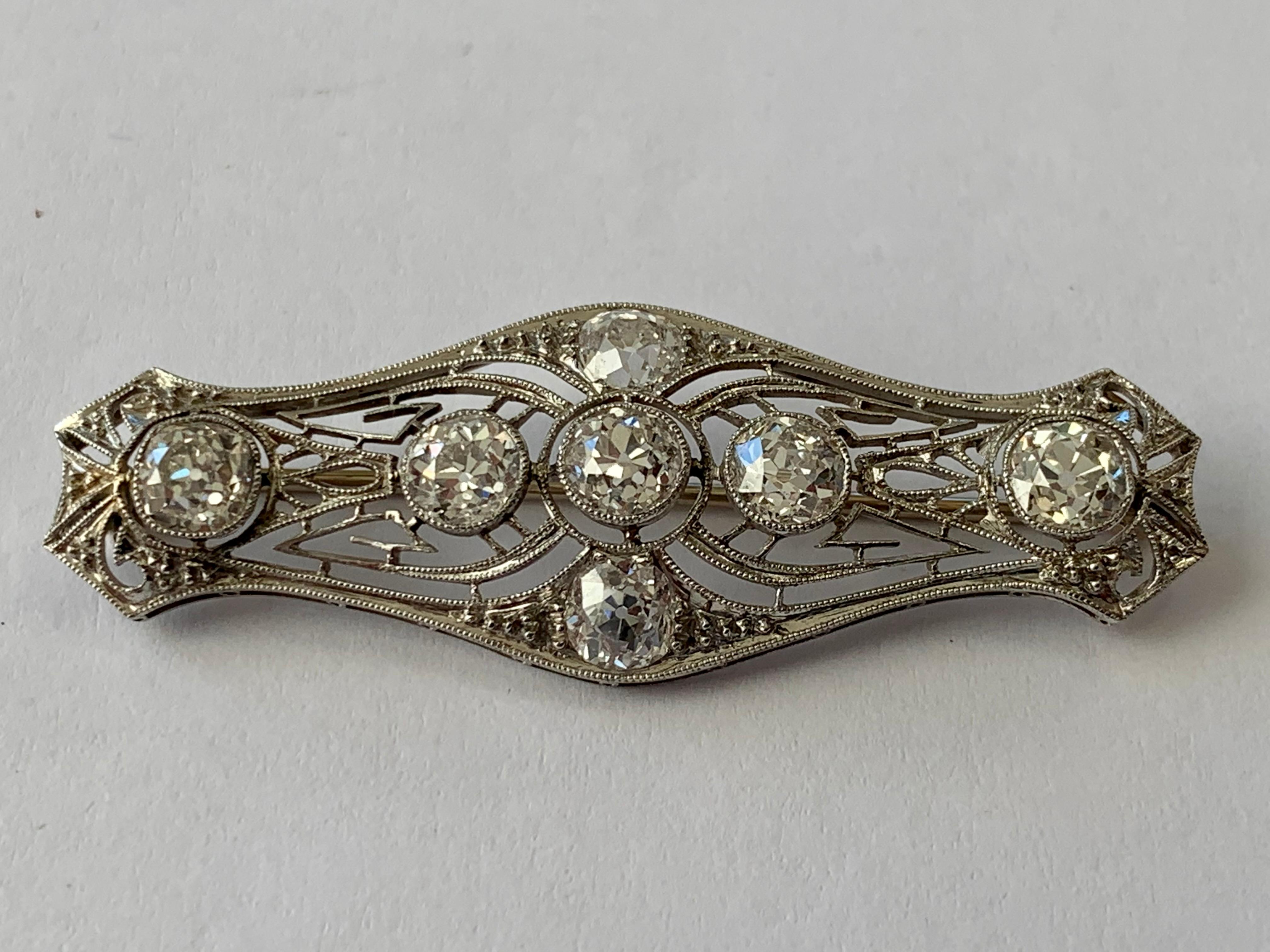 Very decorative openwork brooch mounted in fine Platinum and set 7 old European round cut Diamonds weighing approximately 2.50 ct. Finished with fine millegrain on the platinum edges. Length: 5 cm
Beautifully hand crafted platinum Diamond Brooch