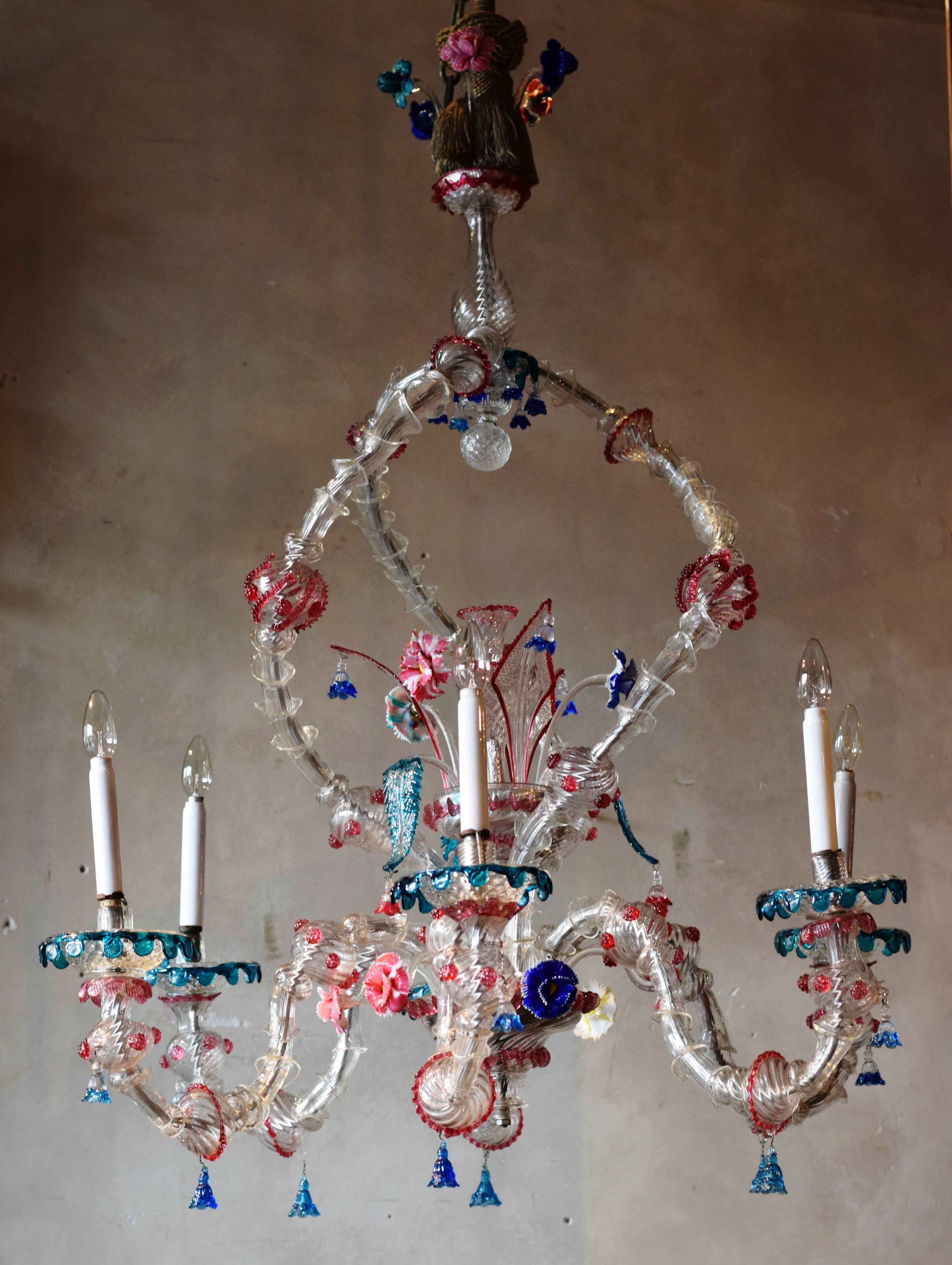 This beautiful, colorful, detailed and very large Ca'rezzonico chandelier was made in Murano, near Venice.

The chandelier is compiled from handblown parts. The amount of detail is astonishing: flowers, leafs, florals and scallops. 

The