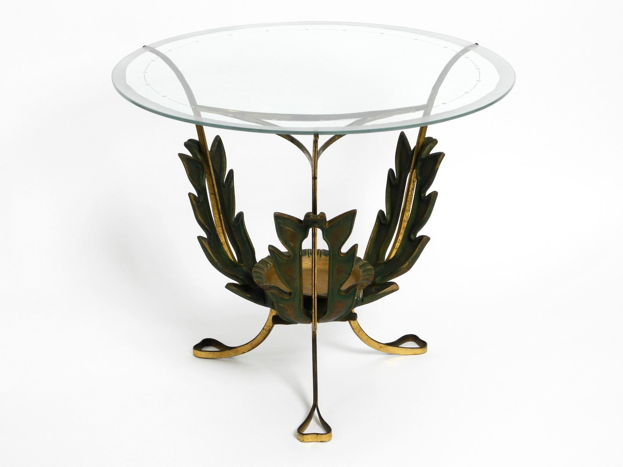 Very rare Italian original midcentury glass brass side table.
Beautiful 1950s floral design in a good vintage condition.
Frame is made entirely of brass and is in the shape of large long green leaves.
Original round glass plate, edge satin