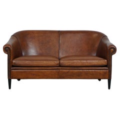 Beautiful and well-maintained spacious sheepskin leather 2-seater club sofa.