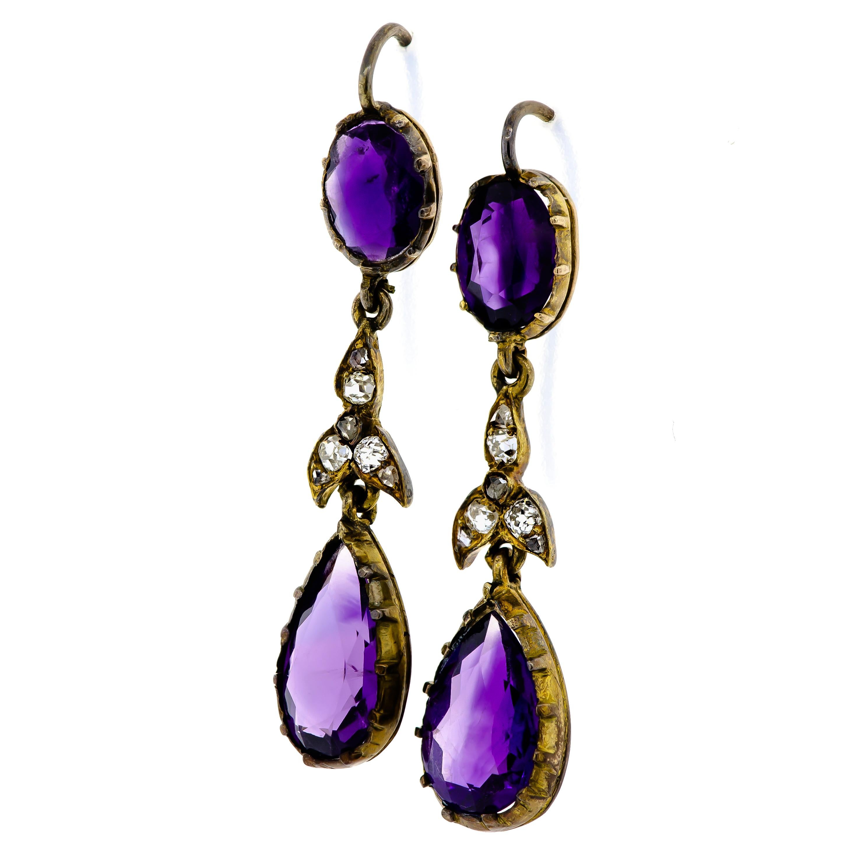 Beautiful Antique Turn-Of-The-Century amethyst and diamond earpendants, circa 1900, oval and pear shaped brilliant cut diamonds bezel set with accents of small round old cut diamonds shepherd hook wires for pierced ears, 14 karat yellow gold,