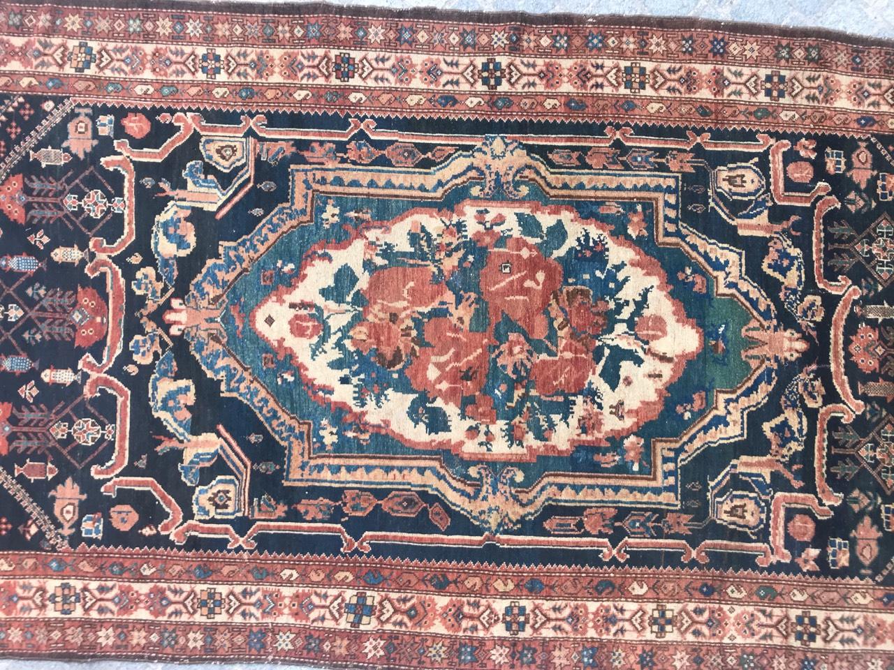 Very beautiful late 19th century Bakhtiar rug with a central medallion floral Savonnerie design, tribal design, and nice colors with orange, blue, green, pink and black blue, entirely hand knotted with wool velvet on cotton foundation.