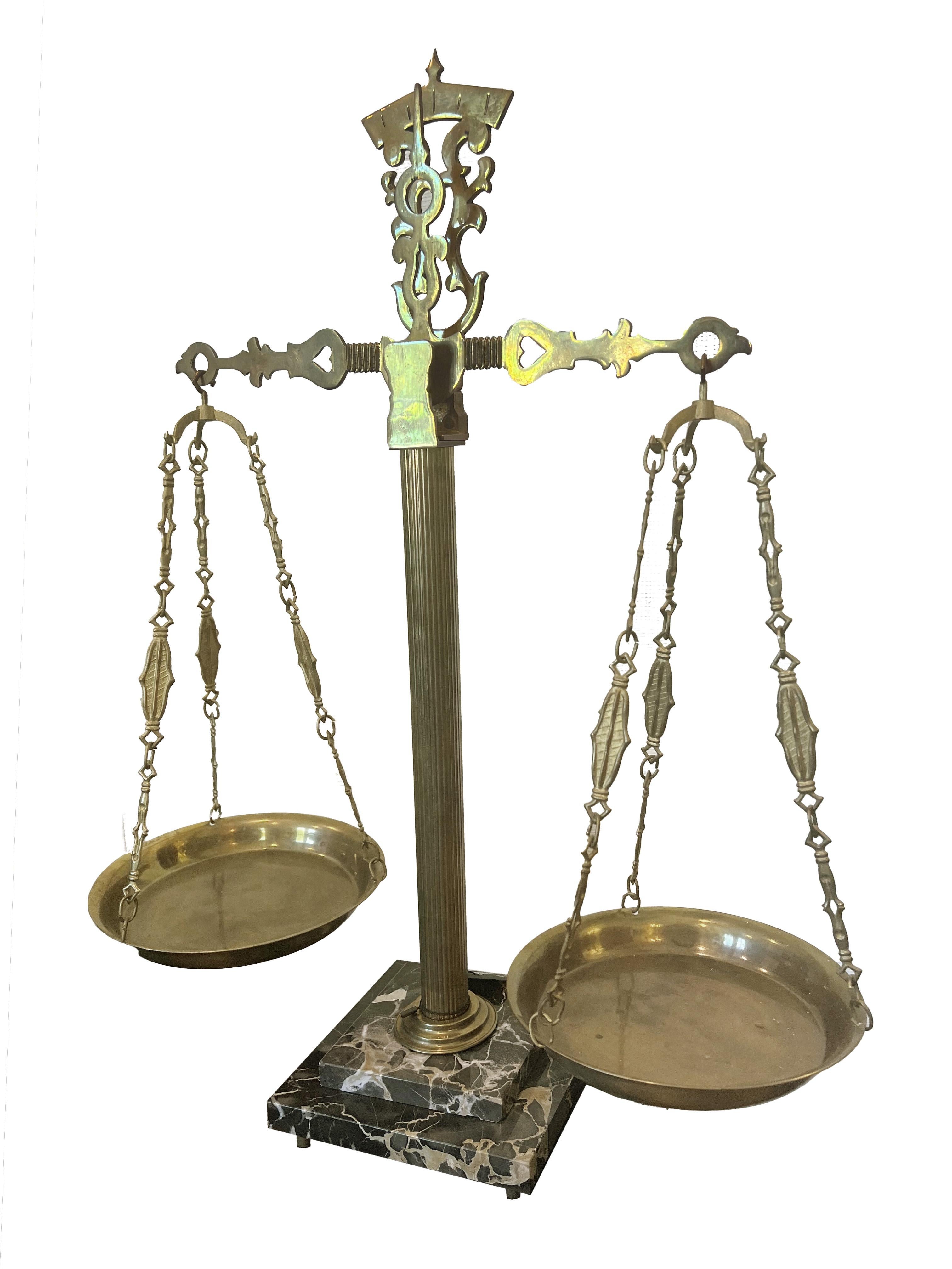 Immerse yourself in the elegance and charm of yesteryear with this exquisite antique brass scale, a true testament to craftsmanship and beauty. This remarkable piece stands proudly on a stunning Portofino marble base, its presence in any room