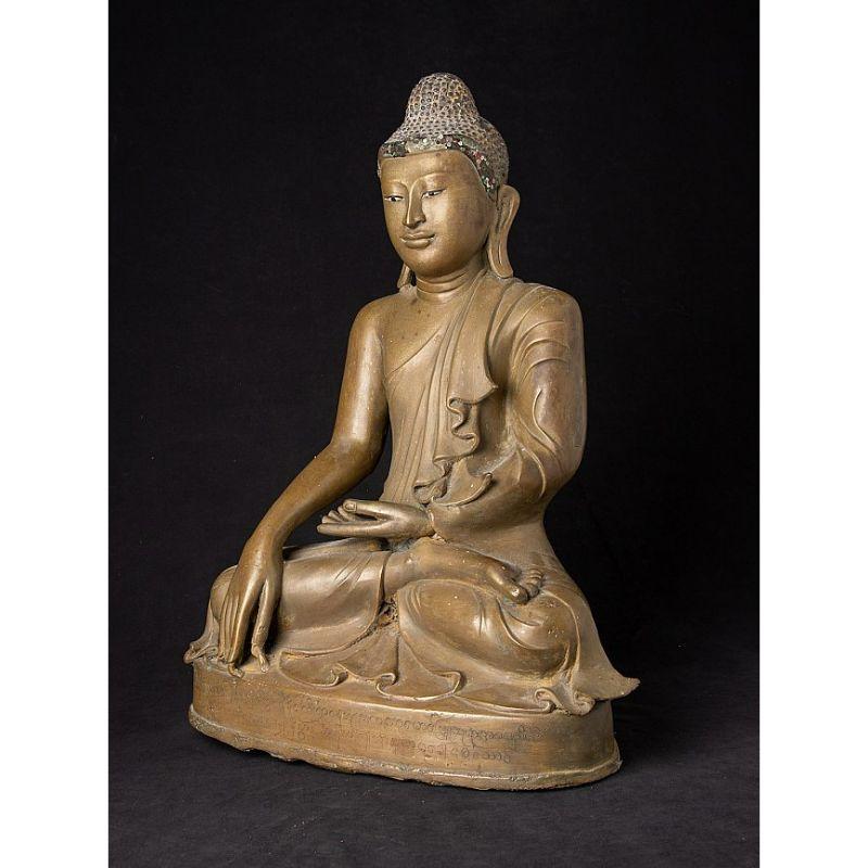 Material: bronze
53,5 cm high 
40,7 cm wide and 22,1 cm deep
Weight: 15.35 kgs
With inlayed eyes
Mandalay style
Bhumisparsha mudra
Originating from Burma
19th century
With Burmese inscriptions, probably the name of the family who once