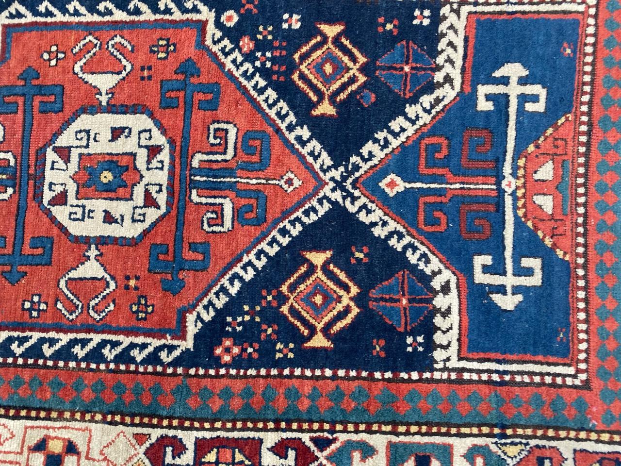 Very nice late 19th century long Kazak rug, with a tribal geometrical Caucasian design and beautiful natural colors, with blue, red, yellow and green, entirely hand knotted with wool velvet on wool foundation.