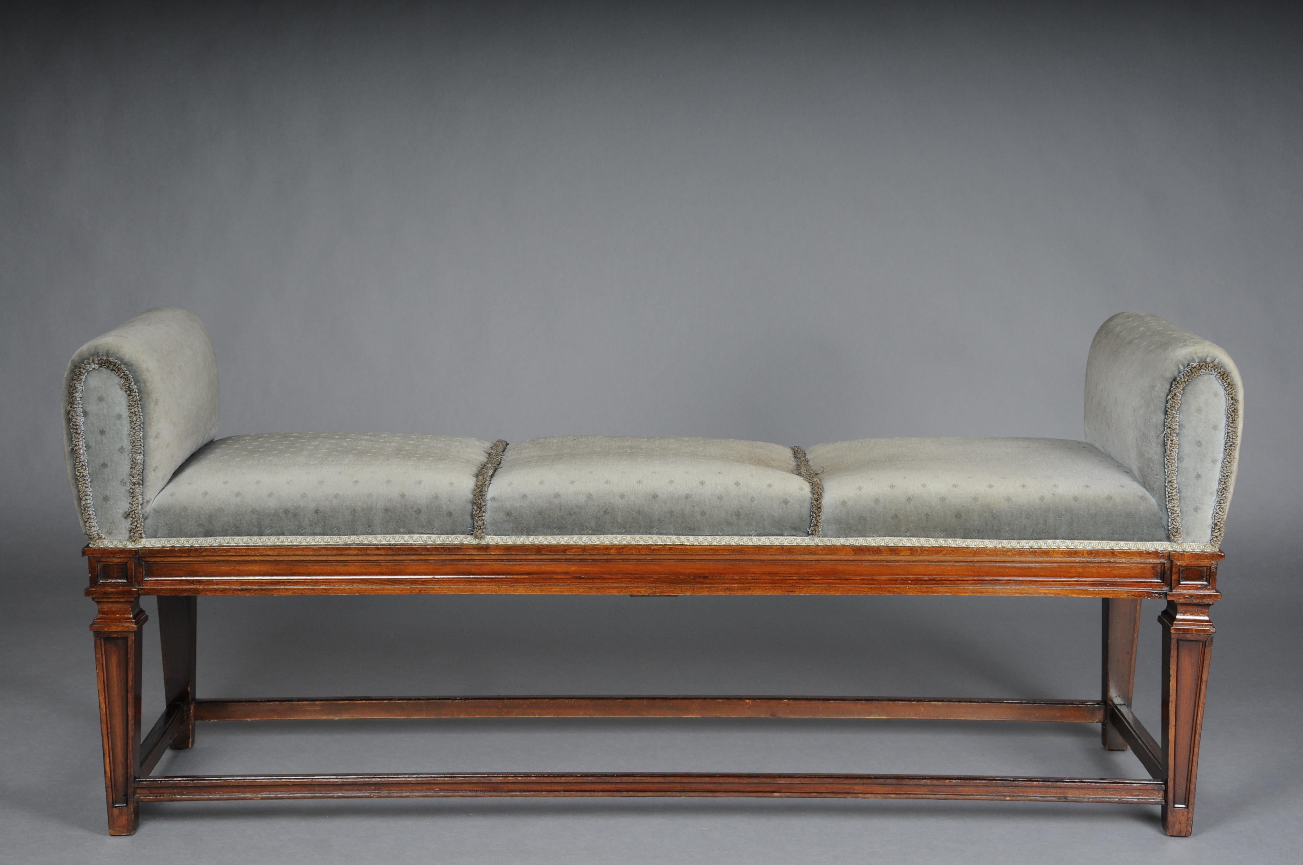 Beautiful antique Empire bench, oak 20th century.

Solid wood, hand-carved oak, conical, tapered legs connected with intermediate struts.

Seat padded and covered with gray fabric.
