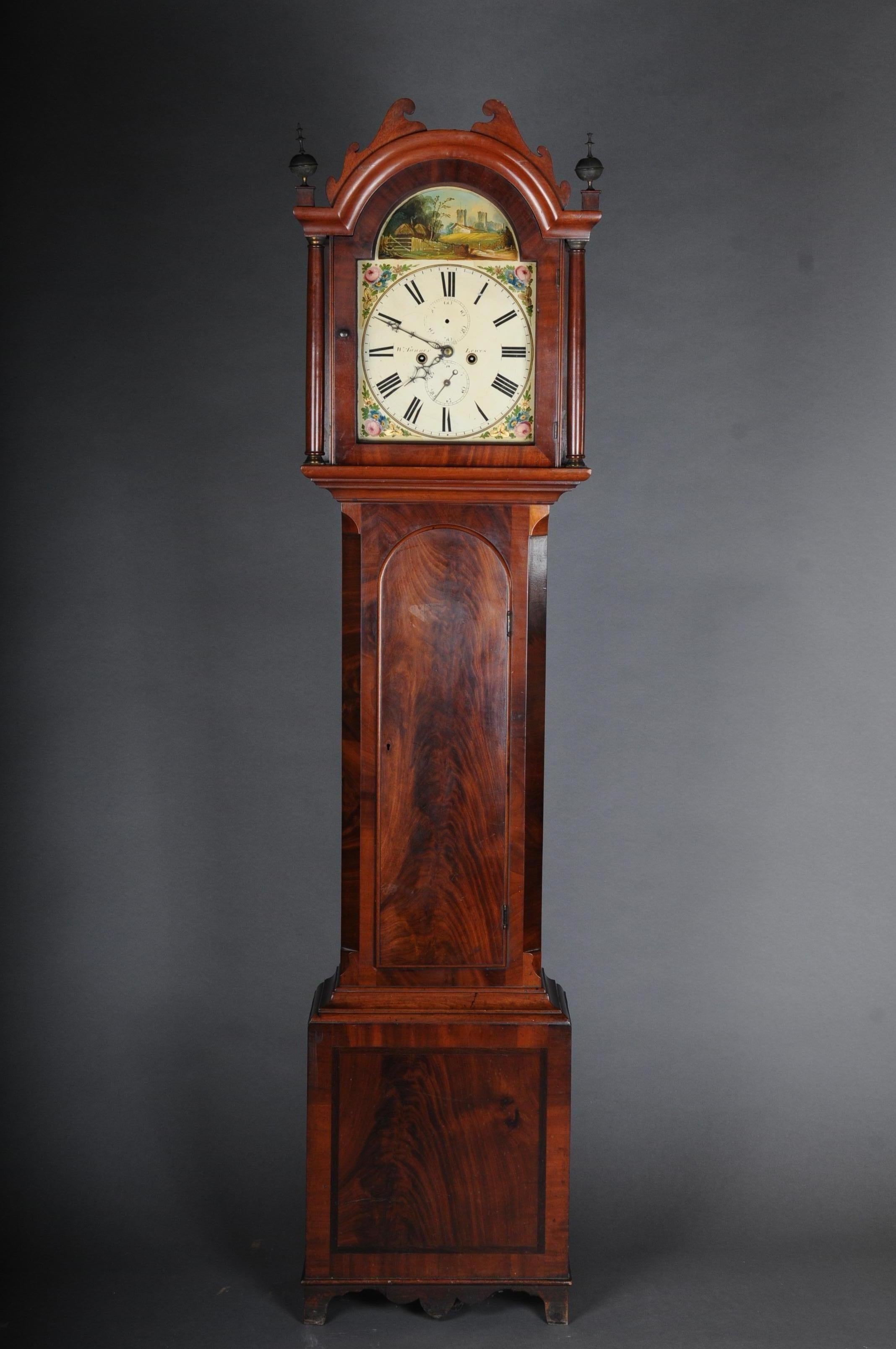 Beautiful antique English grandfather clock, mahogany, 19th century.

English floor clock, oak with thread inlay, hand painted dial with Roman numerals and polychrome painting with a scene “Landscape with Castle Ruins”, inscribed. “W. Tanner