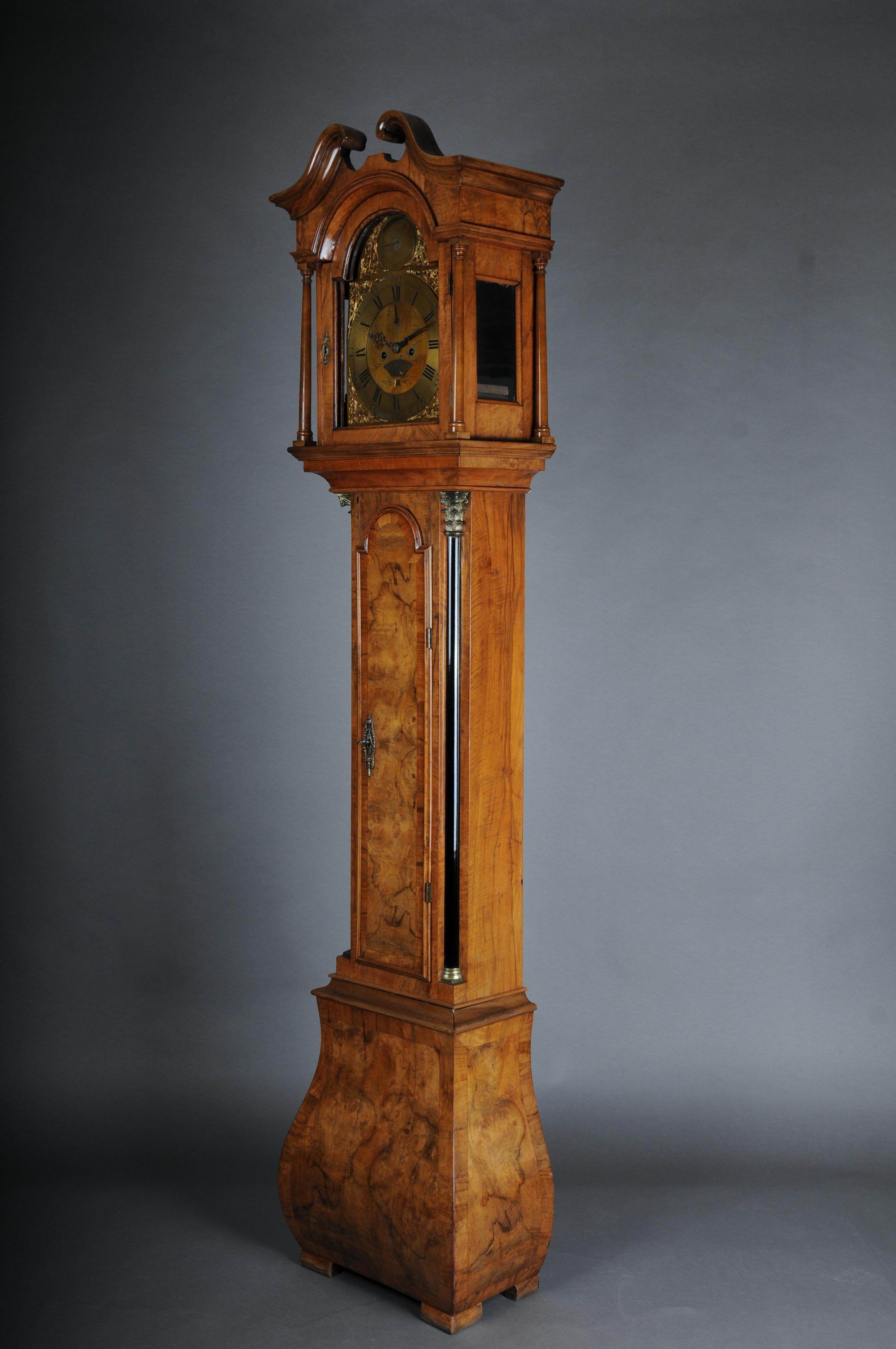 Beautiful antique English grandfather clock, oak, around 1800

walnut/burr wood. Case with ebonized half columns. Glazed, single-door head with solid columns. Brass dial with black Roman numerals, auxiliary dial 