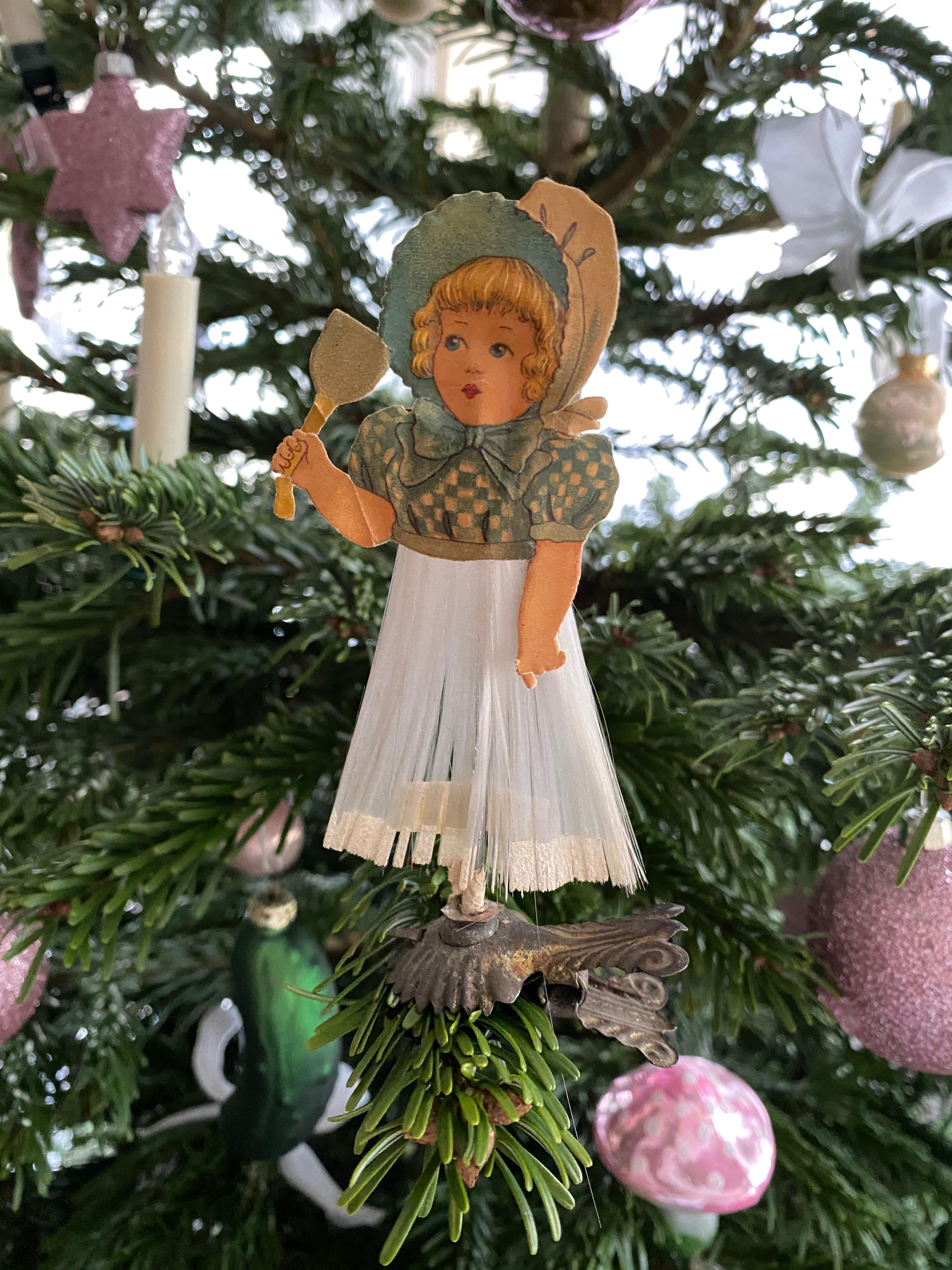 A rare antique clip-on ornament for your collection. This ornament, was made from a Victorian die cut paper scrap and spun glass, would be a great antique addition for your Christmas, feather tree or sitting on a decorative branch in your bathroom