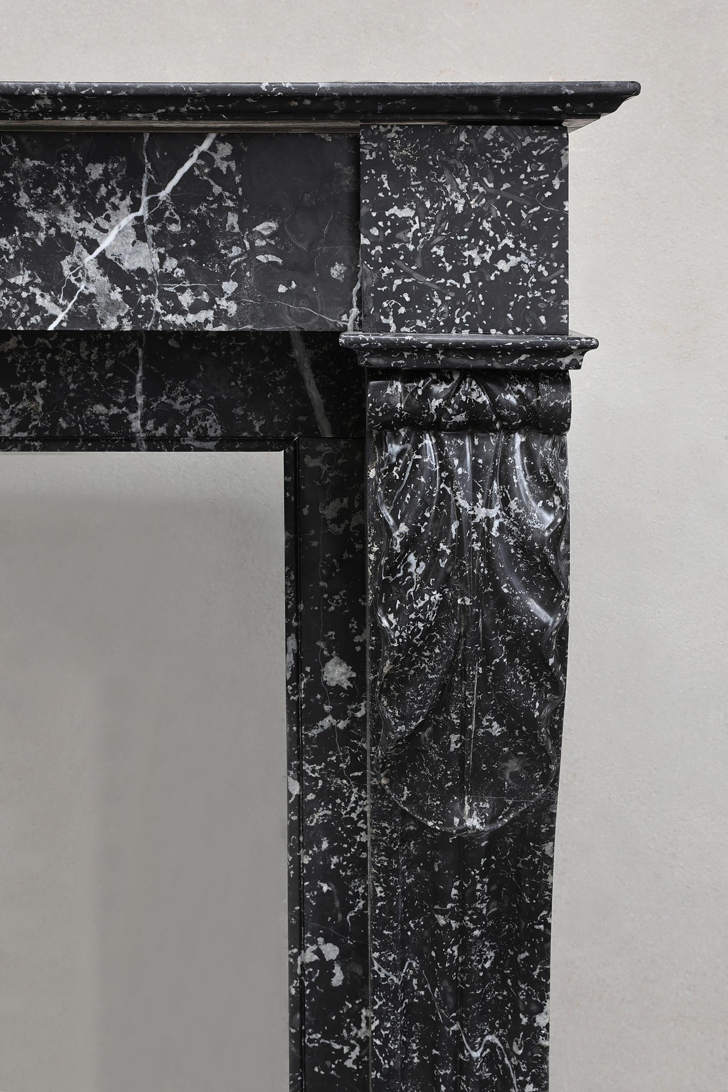 Marble Beautiful antique mantelpiece made of black marble with white veins in the style For Sale