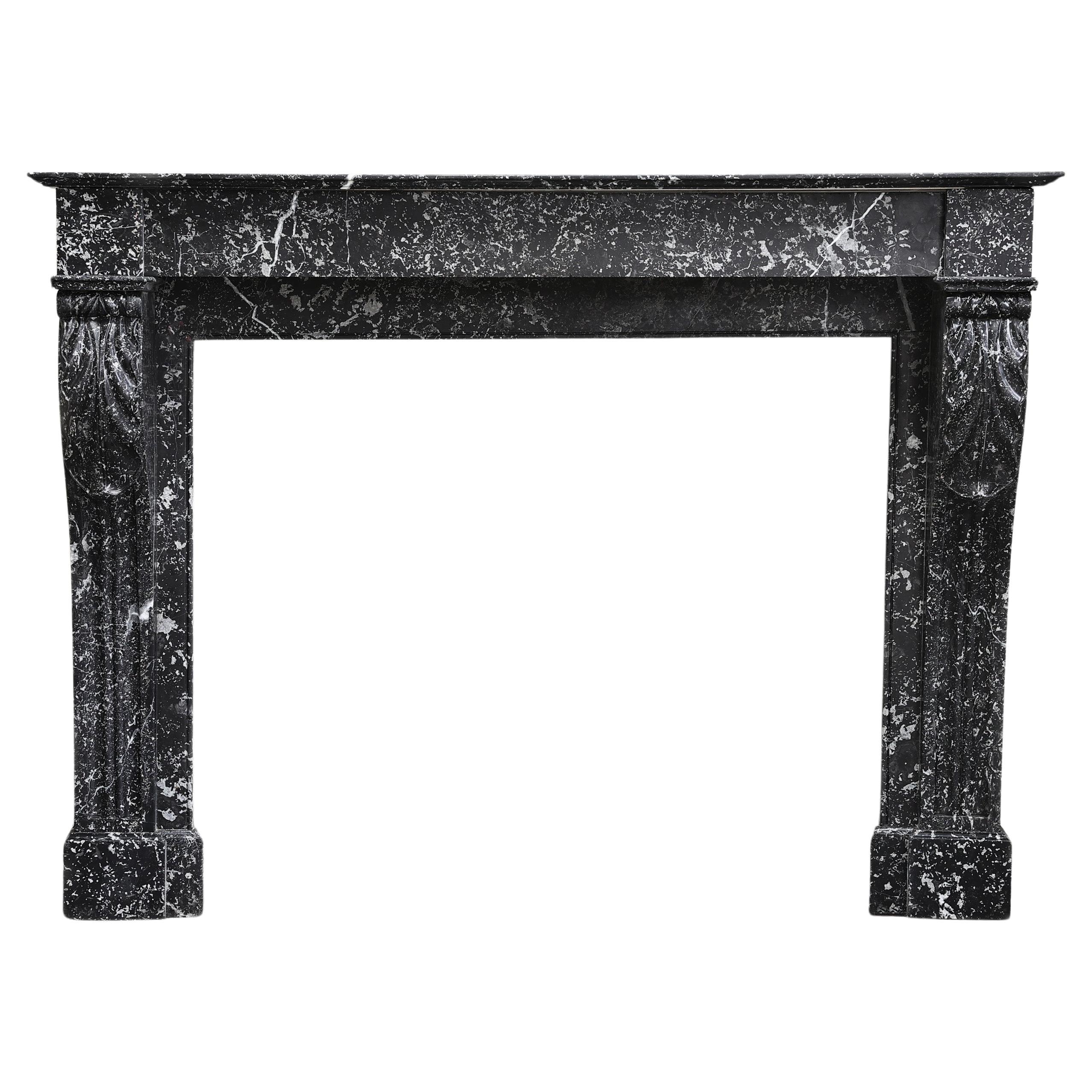 Beautiful antique mantelpiece made of black marble with white veins in the style For Sale