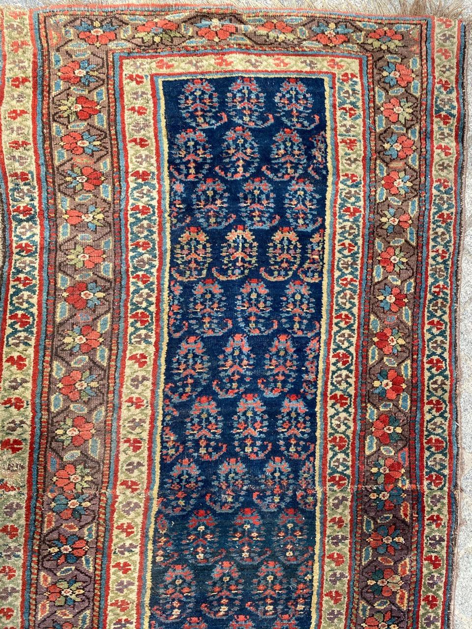 Very beautiful long tribal corridor carpet from the 19th century, with decorative designs by Botteh, and pretty natural colors, entirely hand-knotted in wool velvet on wool foundation.