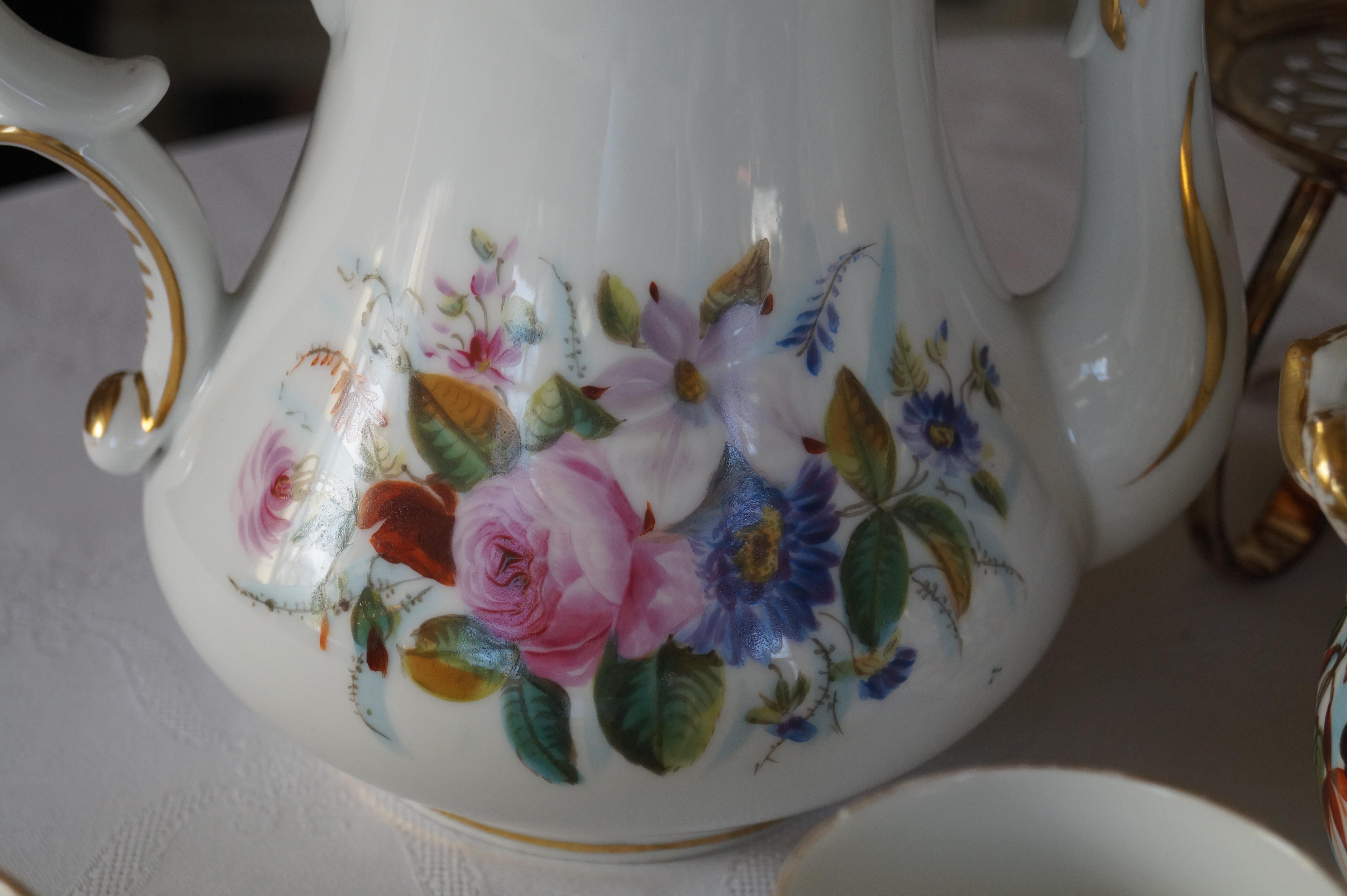 Beautiful antique Old Paris porcelain (Porcelaine de Paris) coffee service. Handpainted with bouquet of flowers and finished with gold decorations. The sugar bowl and creamer were added later, these differ in style. These 2 items are painted on