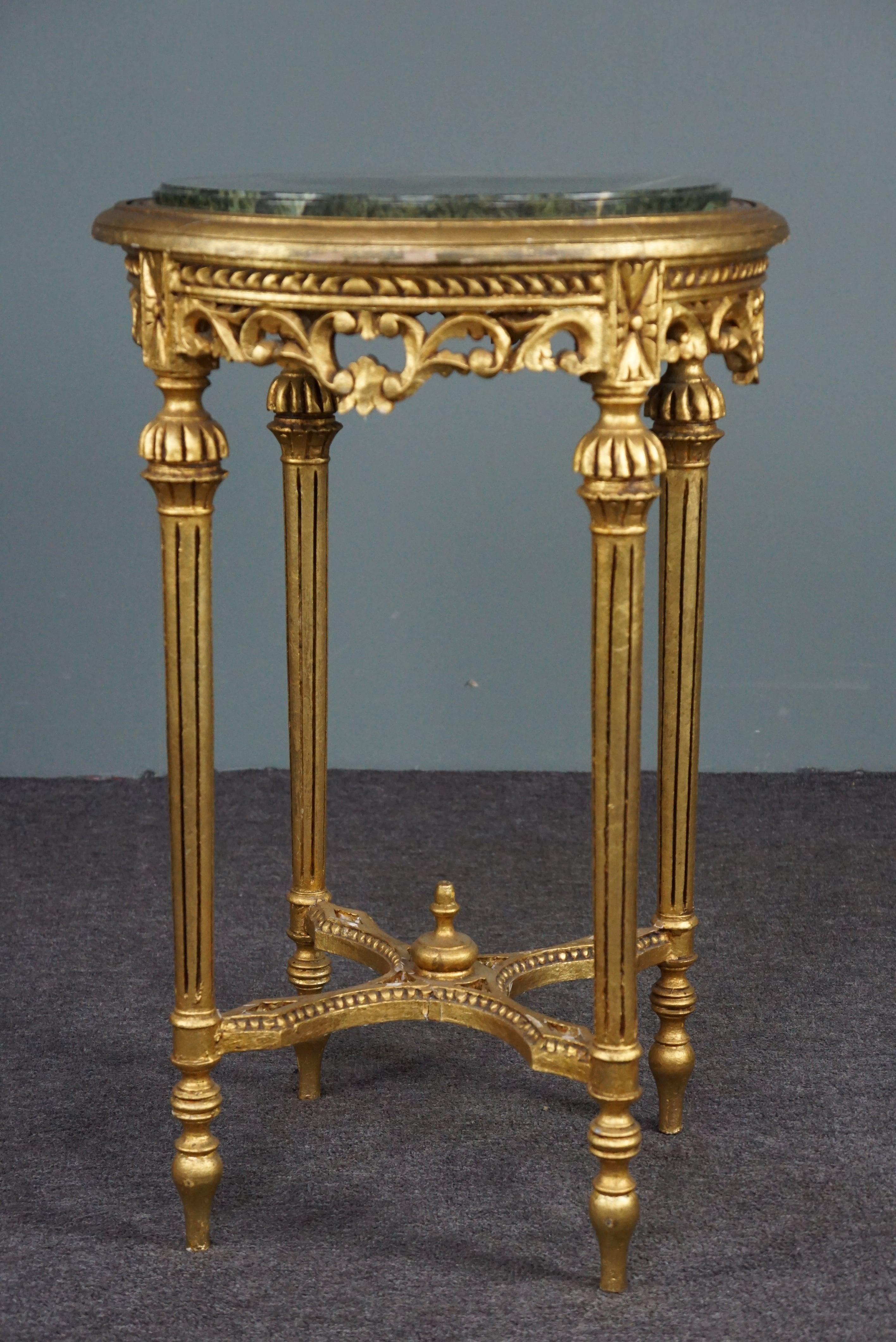 This amazing Italian marble plant stand/table has a beautiful green marble top and a base gilded with gold leaf.

This plant stand from the early 1900s full of details can also be used as a display piece. The hand-carved wood covered with gold leaf