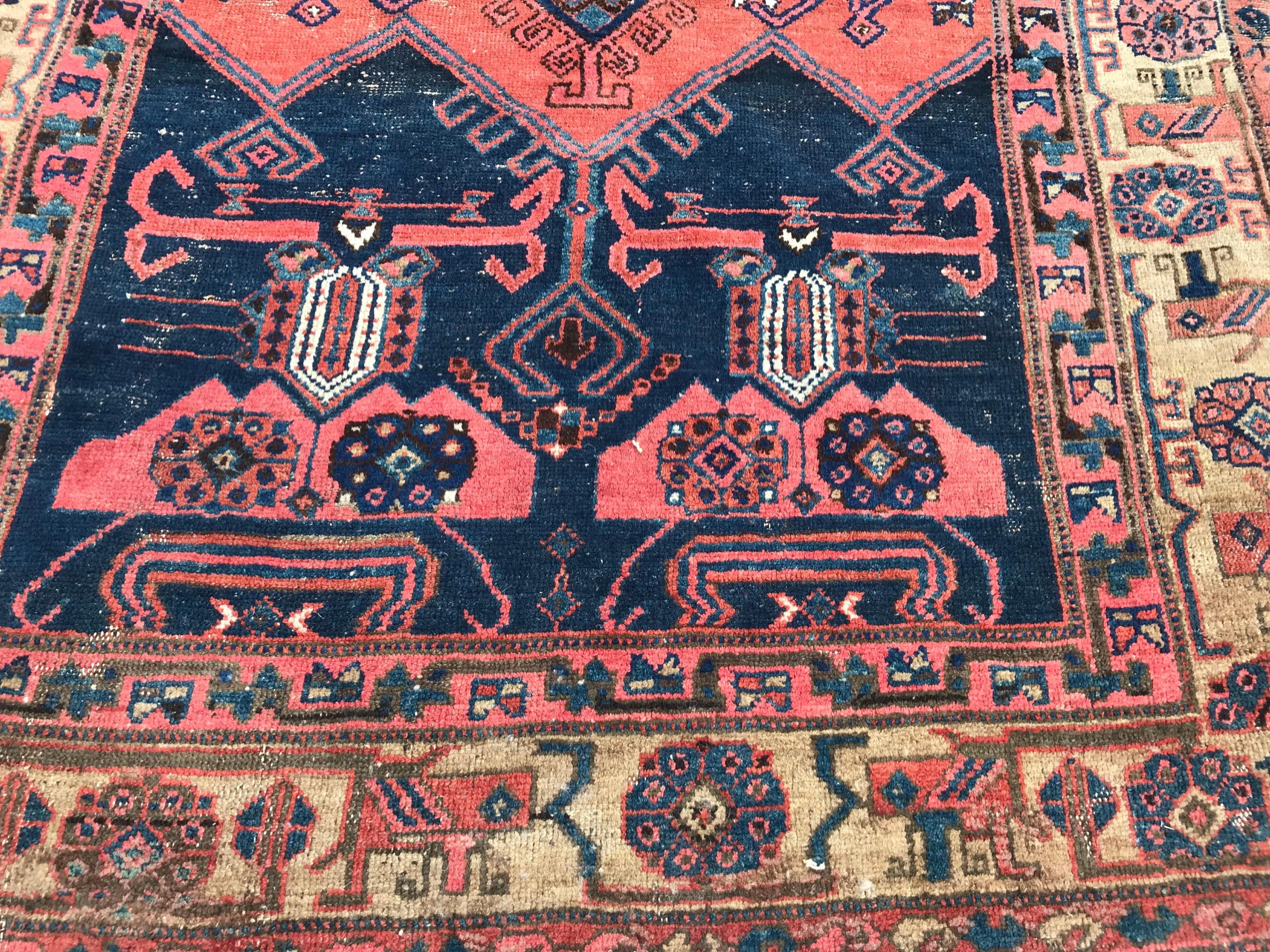 Discover the exquisite craftsmanship of this late 19th-century tribal Kurdish rug. Adorned with a stunning geometric design and natural hues of red, blue, green, yellow, and purple, this hand-knotted masterpiece features wool velvet on cotton