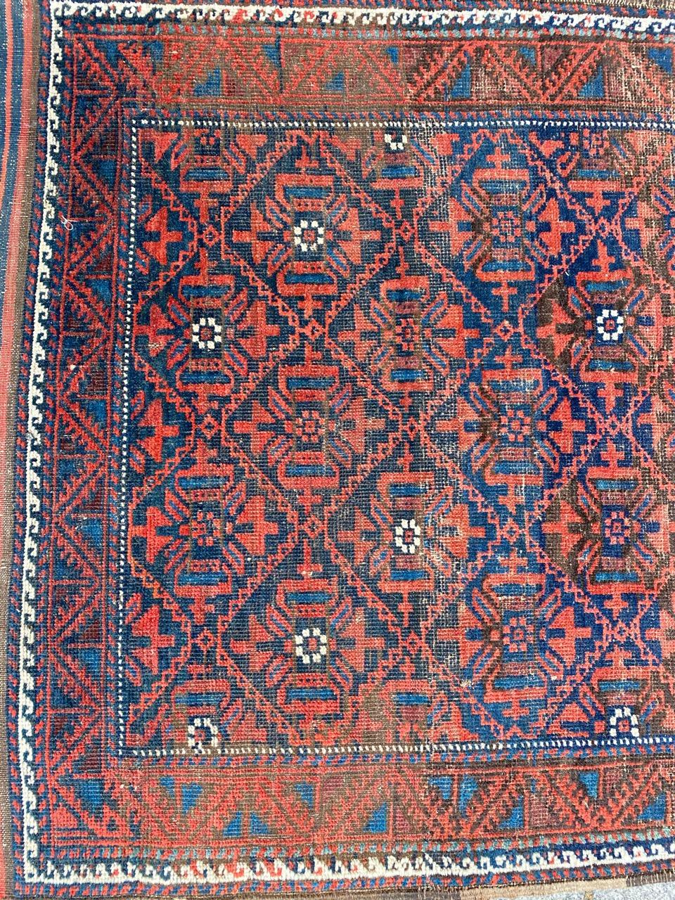 Nice antique Baluch rug with geometrical tribal design and beautiful natural colors, entirely hand knotted with wool velvet on wool foundation.