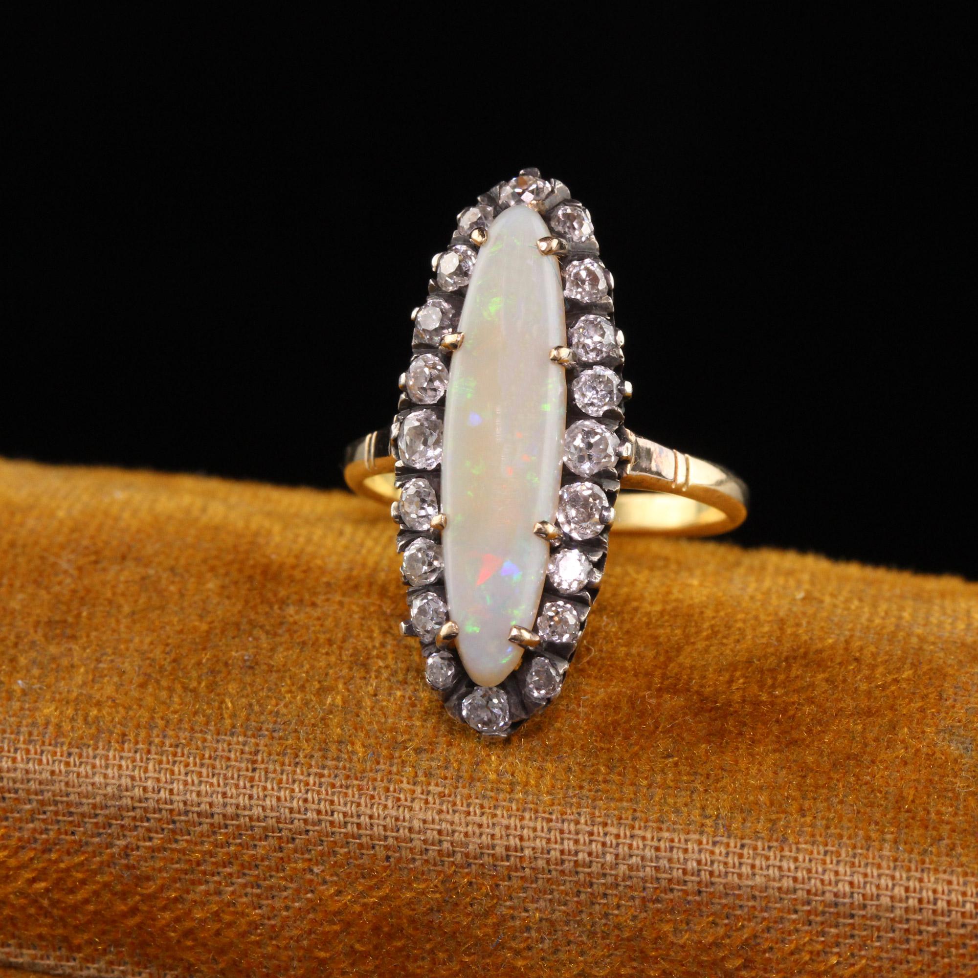 Beautiful Antique Victorian 14K Yellow Gold Silver Top Opal and Old Mine Diamond Ring. This gorgeous Victorian ring is crafted in 14k yellow gold and silver top. The center holds a long cabochon opal that has vibrant colors flashing in the sunlight.
