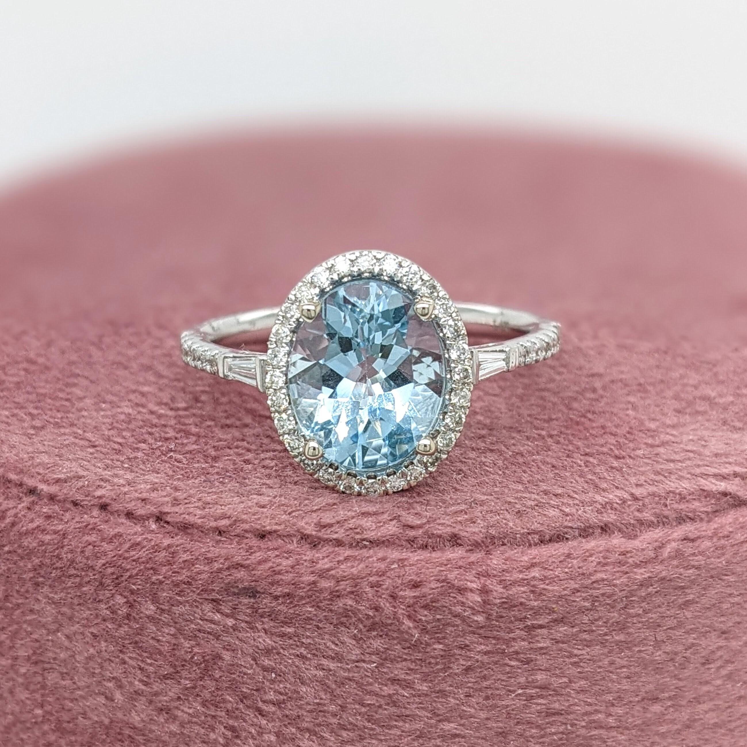 This beautiful ring features an oval sparkling Aquamarine in 14k white gold with a lovely halo of round natural diamonds. A statement ring design perfect for an eye catching engagement or anniversary. This ring also makes a beautiful birthstone ring