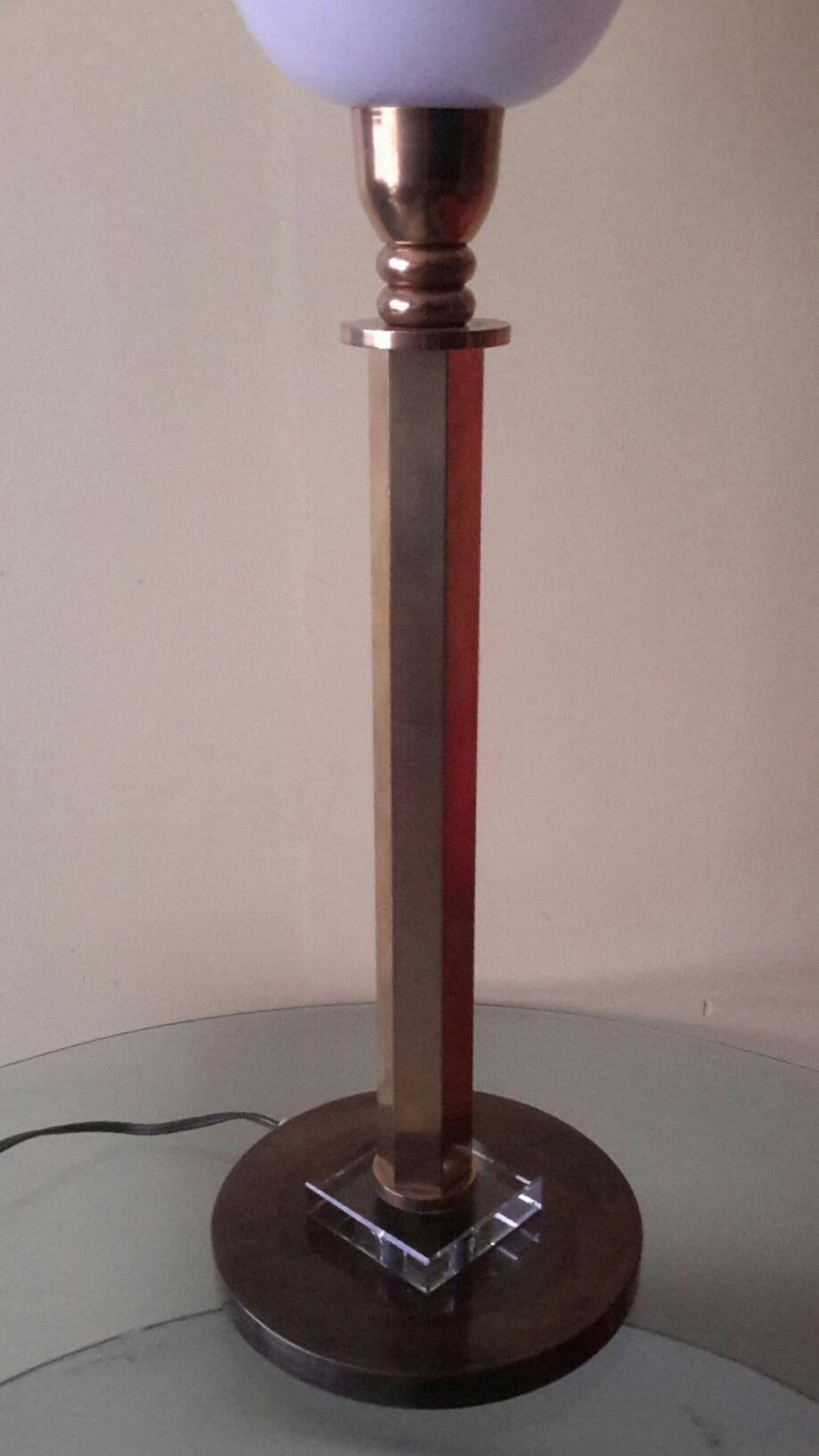 Beautiful Art Deco table lamp in bronze with two different patina, gilt and dark brown and ornament part in crystal, with opaline lampshade.

The lamp is in perfect condition, electrical parts fits the US Standard ( maxi 100 watts )

Dimensions