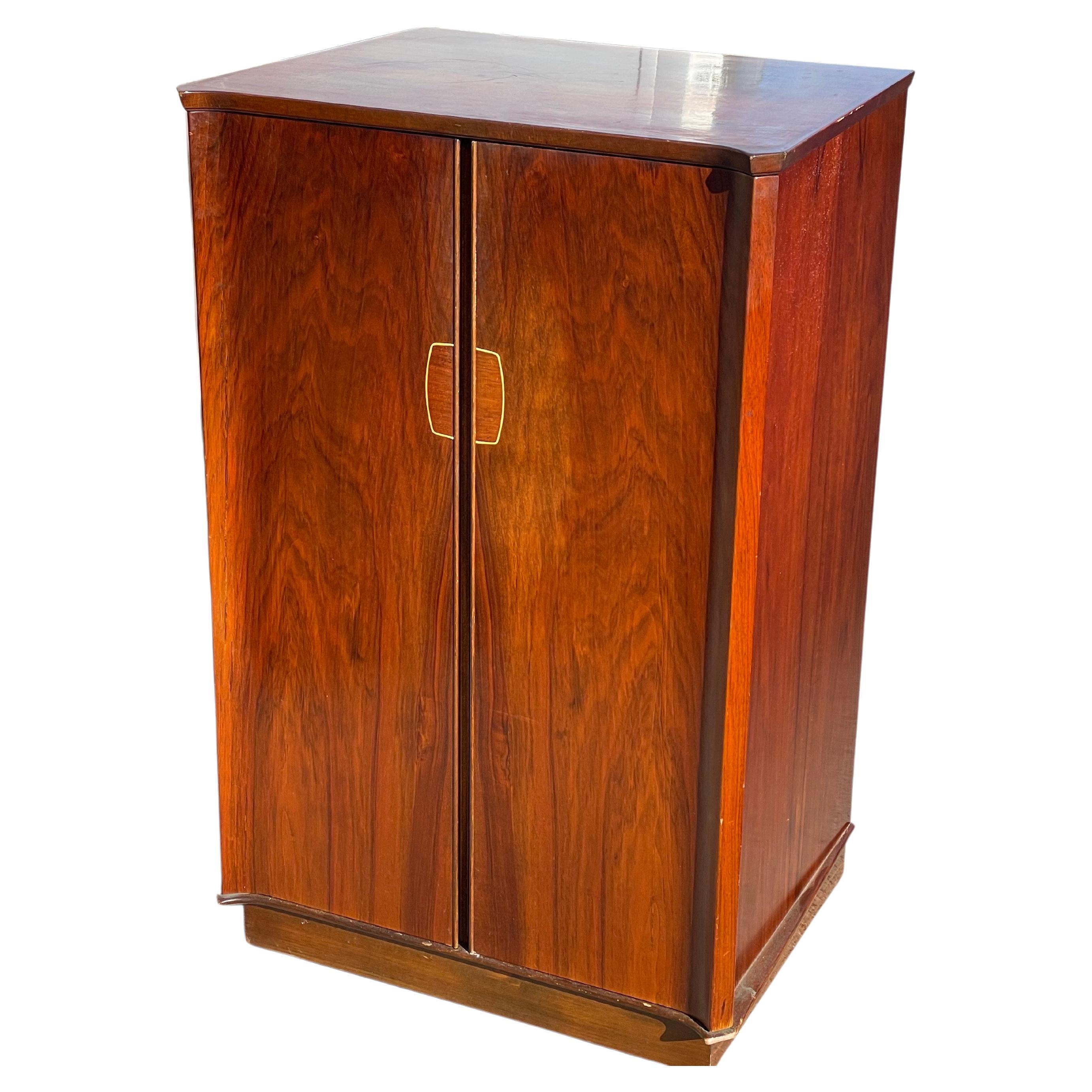 Introducing a piece of history - an Art Deco cabinet from the 1930's that has been repurposed as a bar/fridge, but with endless possibilities for customization. This unique piece of furniture design is a true statement piece that will always stand