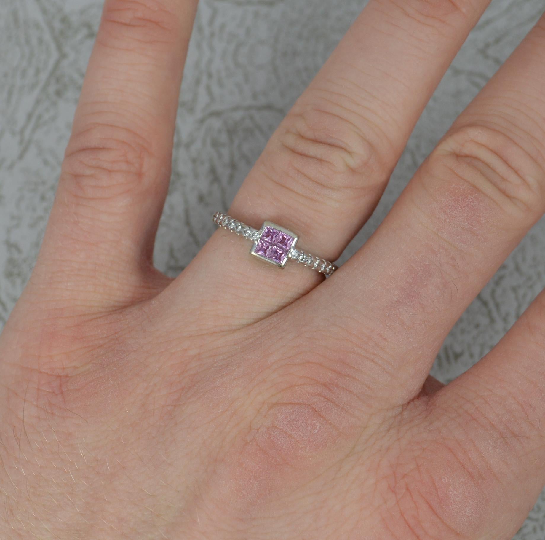 A beautiful contemporary pink Sapphire and Diamond ring.
Solid 18 carat white gold example.
Designed with four princess cut pink sapphires to the centre in a bezel setting. To each shoulder are seven round brilliant cut diamonds. All natural.
6mm x
