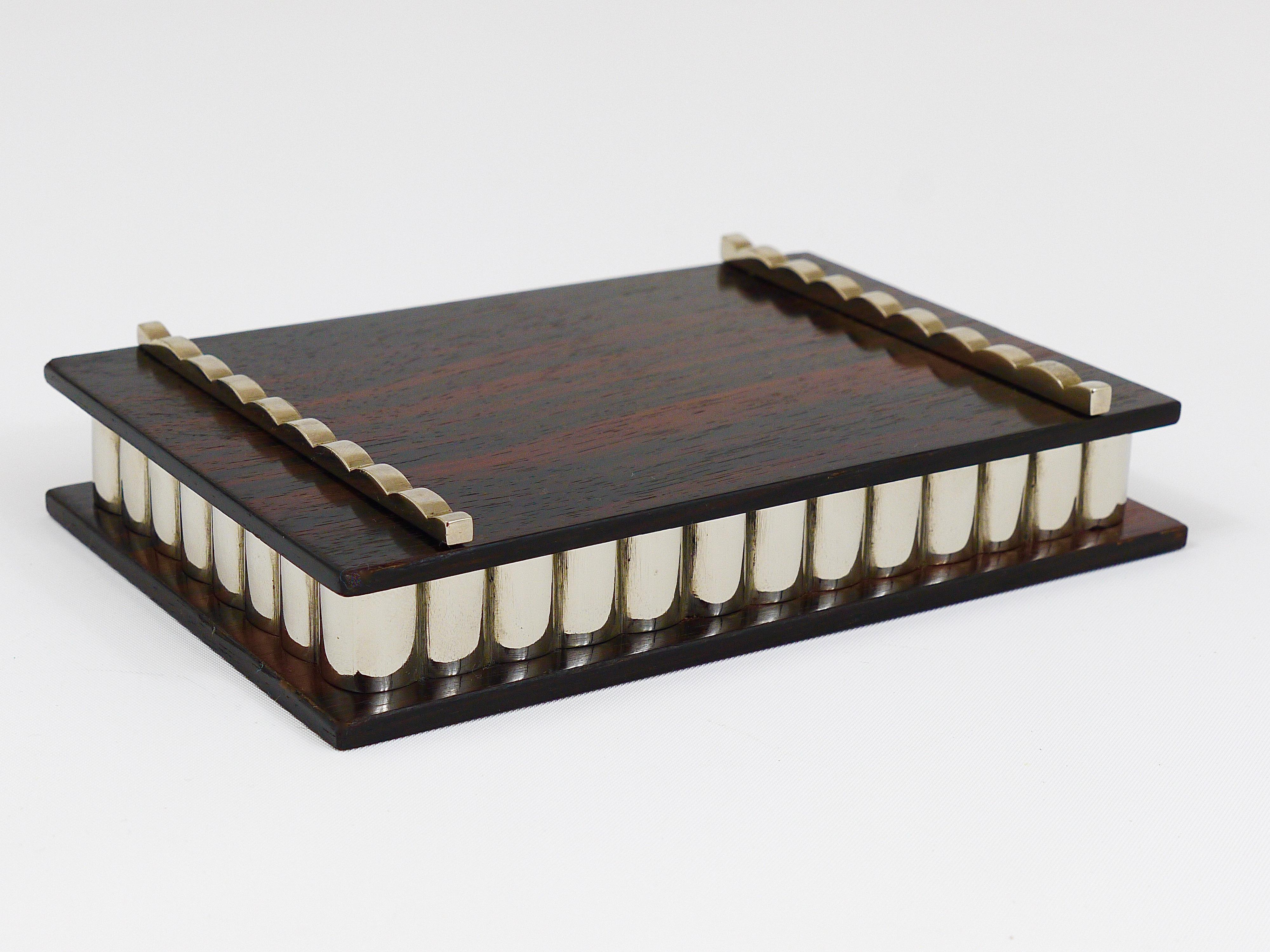 A beautiful Art Deco storage / jewelry or cigarette box, dated circa 1930s. Handmade in Vienna / Austria of macassar / ebony wood, with beautiful nickel-plated metal details. In excellent condition.