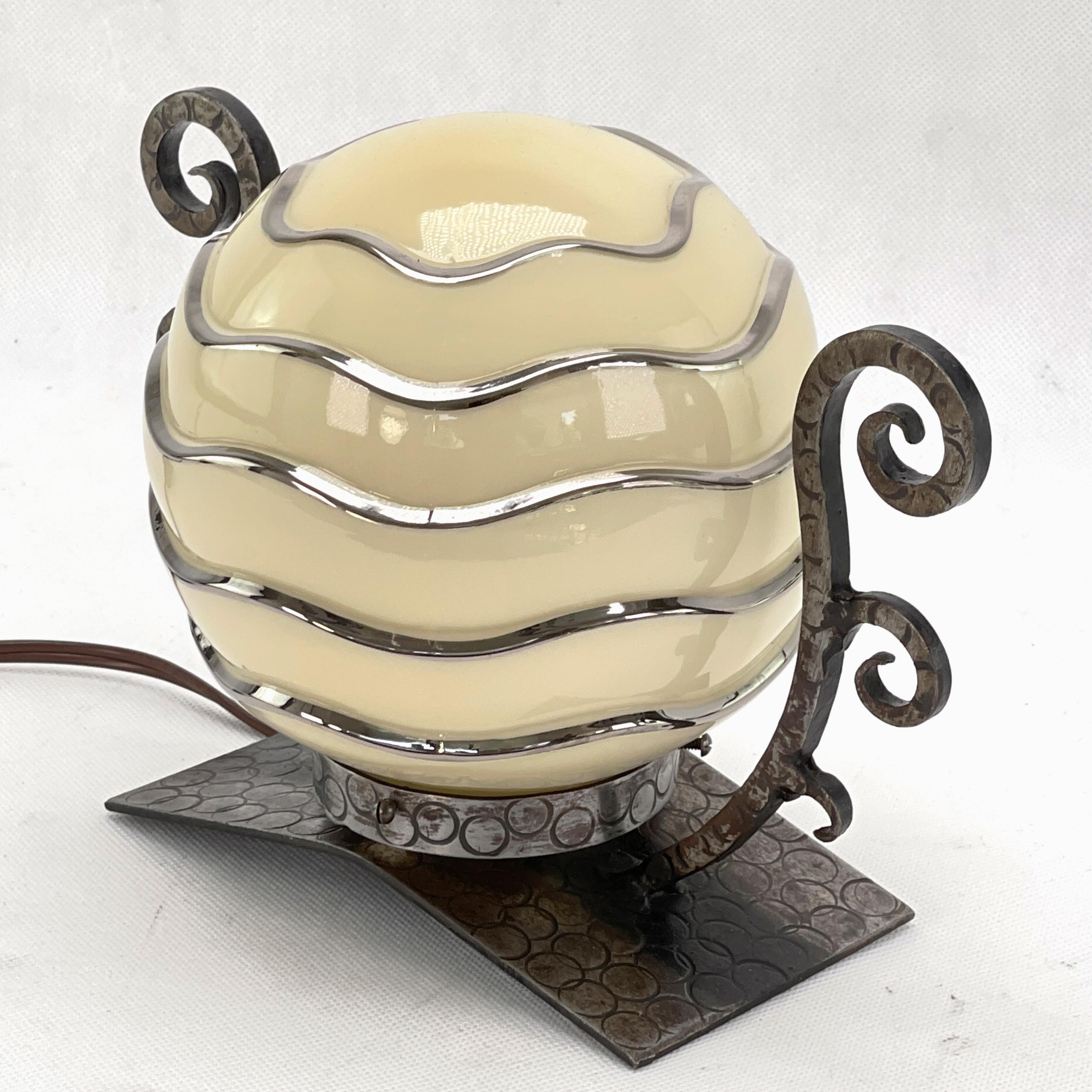 This original table lamp captivates with its simple and matter-of-fact Art Deco design. The decorative lamp gives a very pleasant light. This beautiful table lamp is an absolute design classic from the ART DECOS period. 

The lamp glass has a