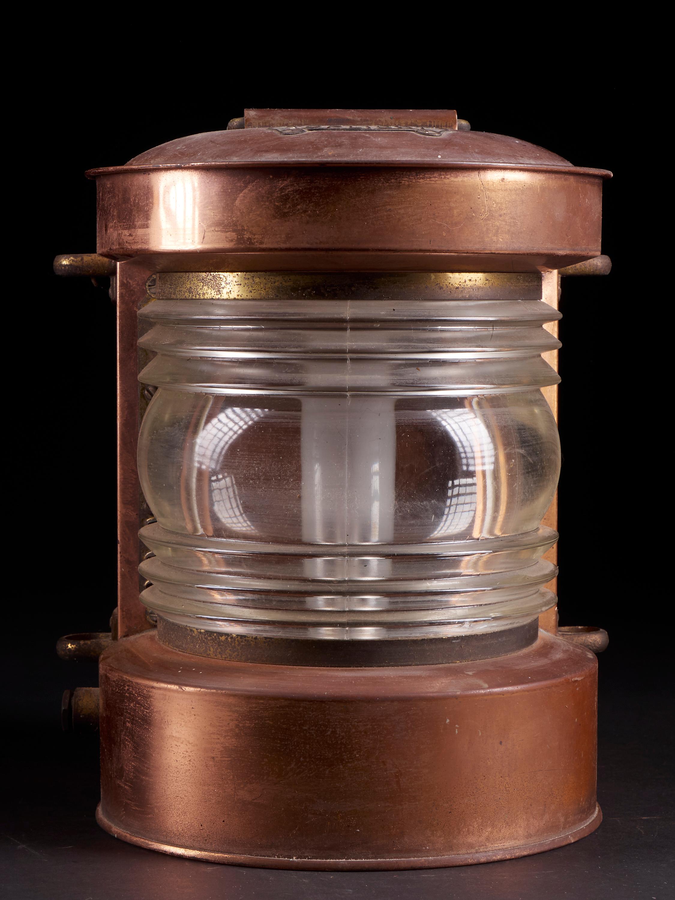 Vintage Art Deco copper alloy Signal lamp from the brand Toplicht with a rectangular box and a rounded, ribbed glass front. The lantern has a bayonet bulb socket and a handle on top.