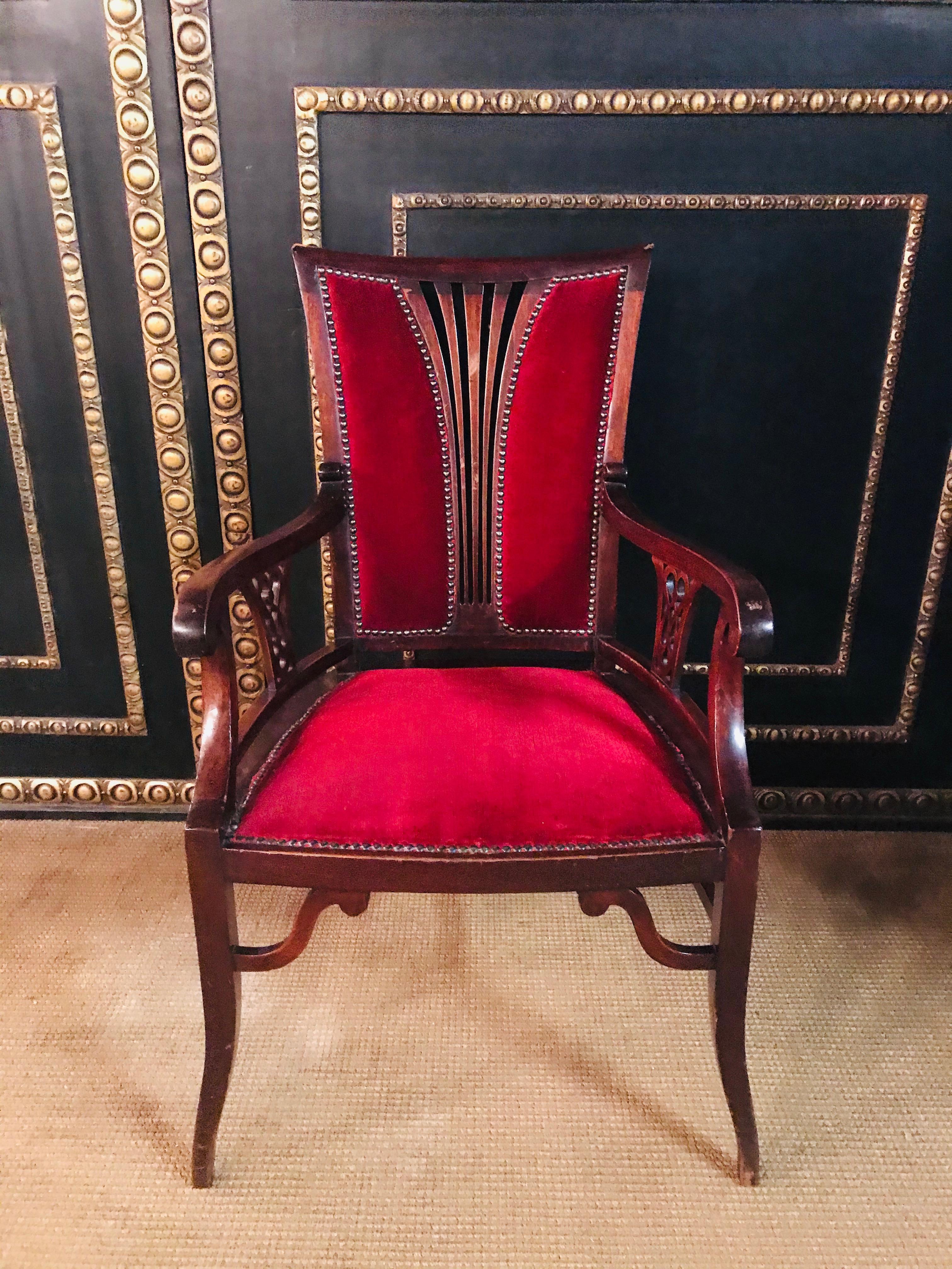 Solid mahogany wood carved backrest.
Armchair with long, curved legs.
Red upholster.