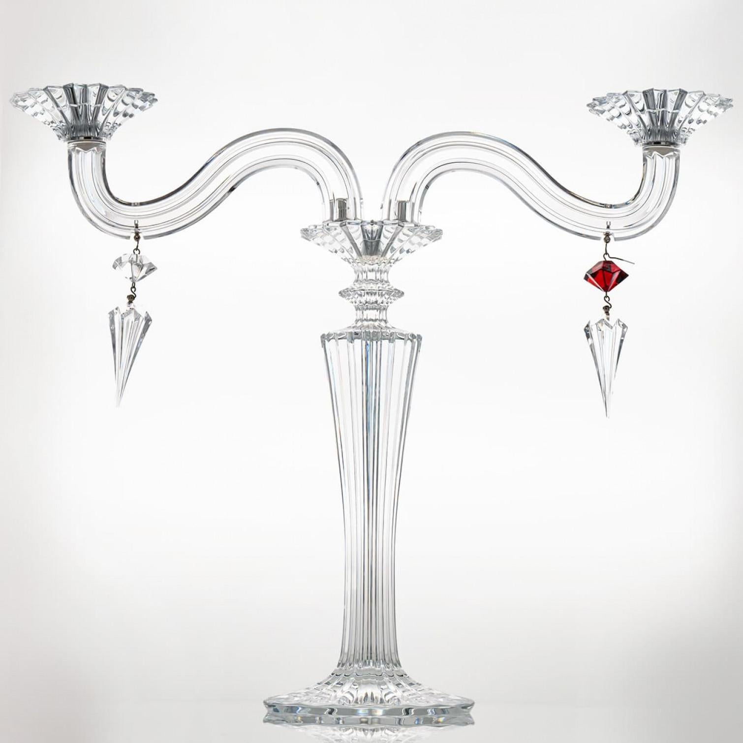 A crystal masterpiece of beautiful proportions, this candleholder crystallize the extraordinary know-how of the Baccarat craftsmen. The different cuts in the crystal produce a magic visual effect.

The two-light candle holder, with two arms on a