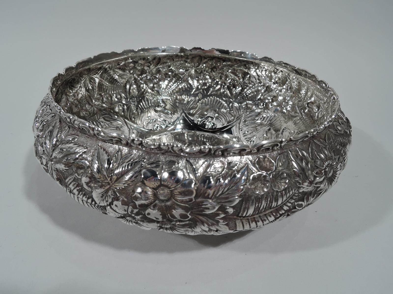 Beautiful repousse sterling silver bowl. Made by Jacobi & Jenkins in Baltimore, circa 1890. Plain circular well and curved sides with floral repousse on stippled ground: Pretty blooms and ferns are framed by plain 8-point star emanating from base.