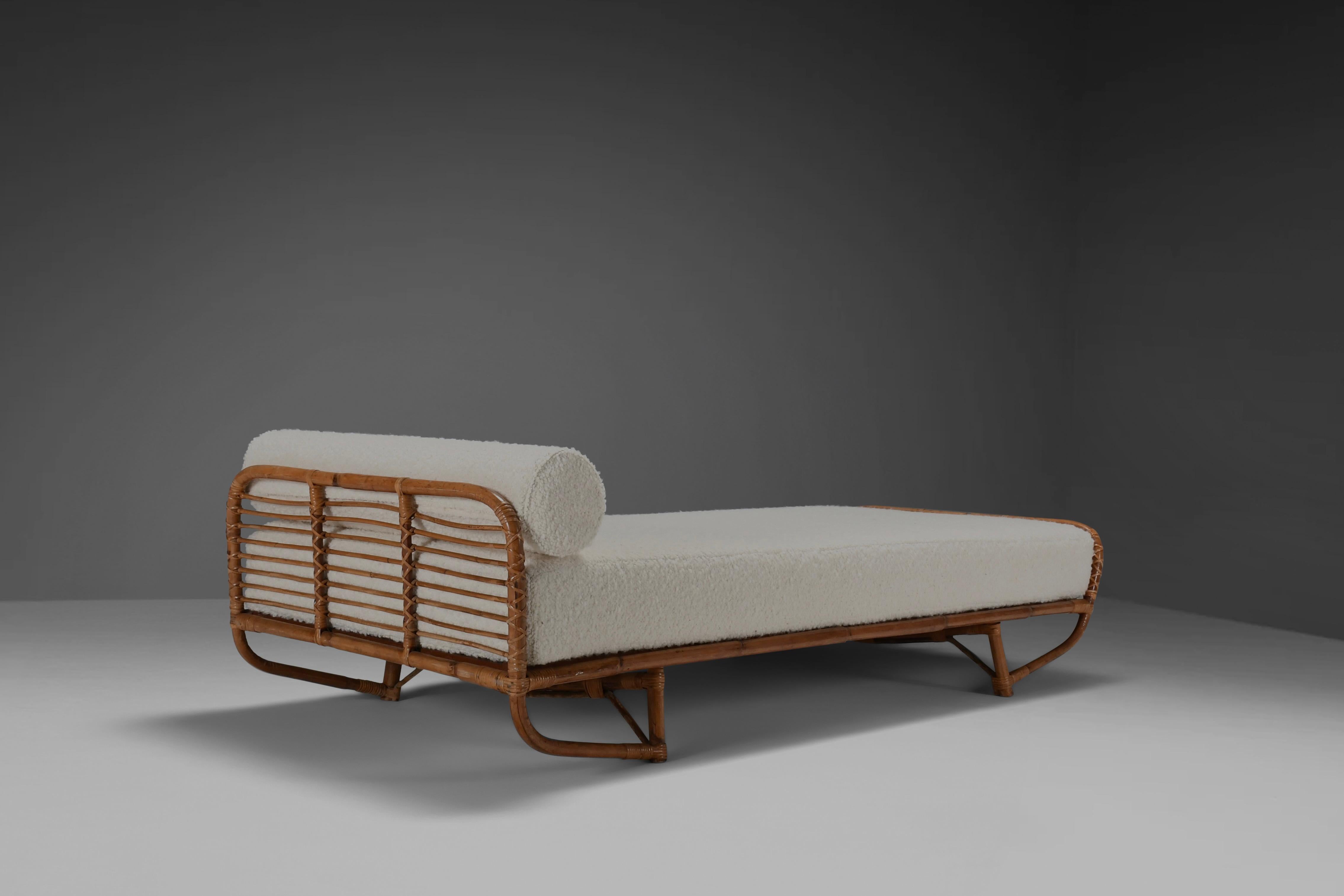 Beautiful high quality daybed in very good condition.

Two available. 

This exquisite midcentury daybed is handmade using the highest standards of quality and craftsmanship

It is woven with bamboo and rattan, the new custom mattress and bolster