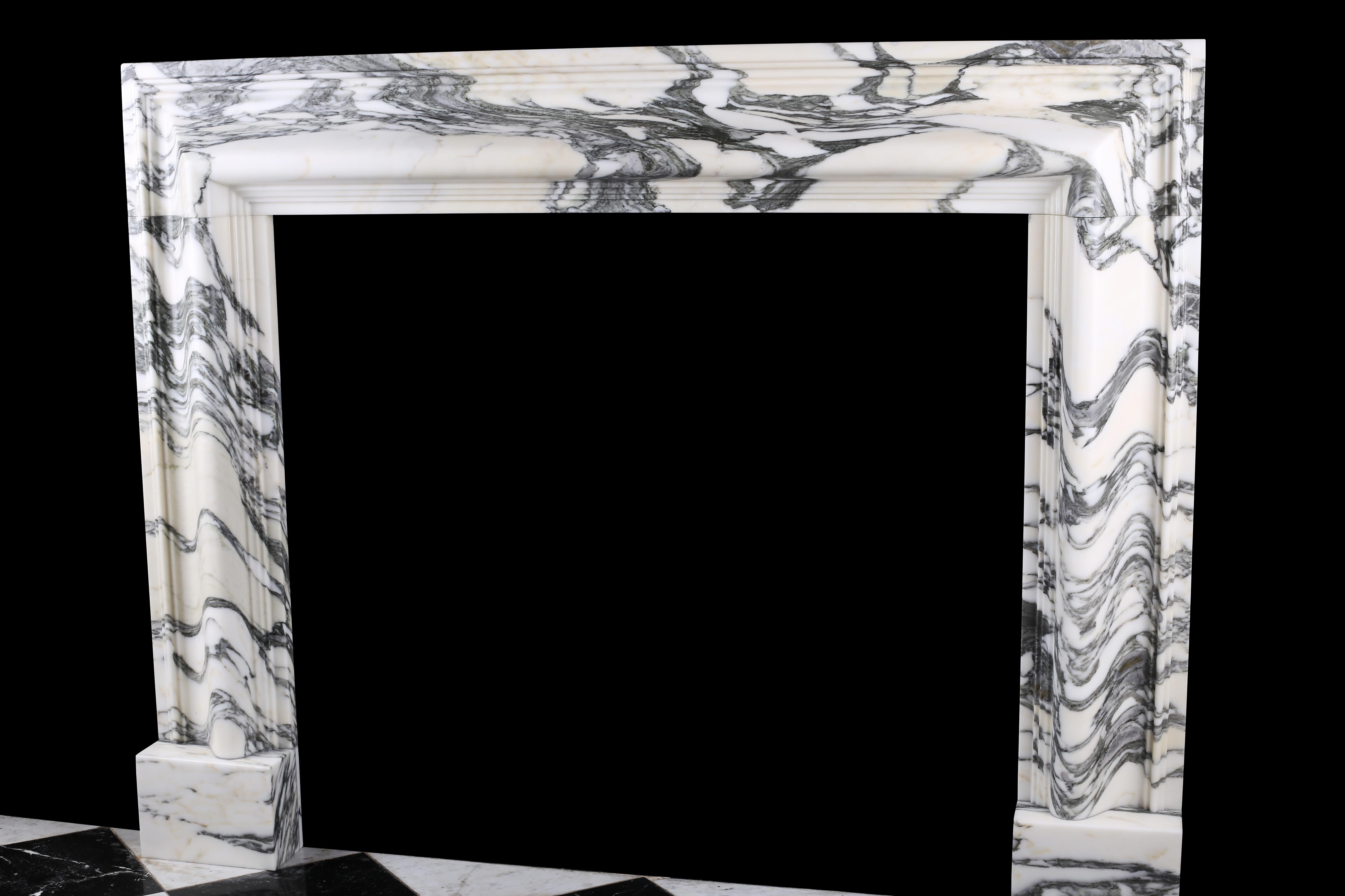 Beautiful Baroque Bolection fireplace in Italian Arabescato marble

A Baroque style Bolection fireplace surround of bold proportions with very finely carved columns with a rising ogee edging, which are supported on substantial footblocks, in high