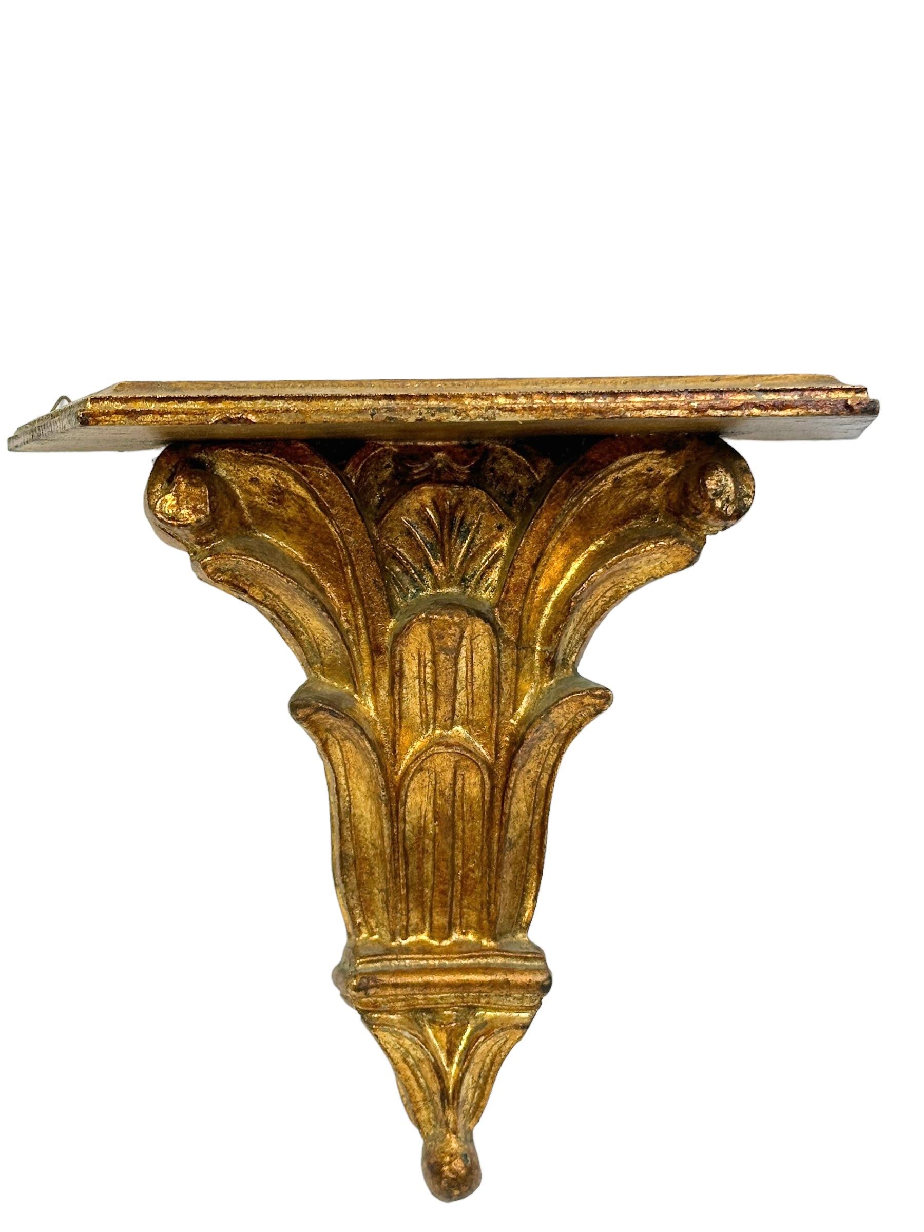 Offered is an absolutely stunning, 1950s wall console or shelf. Minor patina gives this piece a classy statement. Made of hand craft wood, covered with plaster and gilded. Use just as a decorative shelf or put one of your favourite objects on top