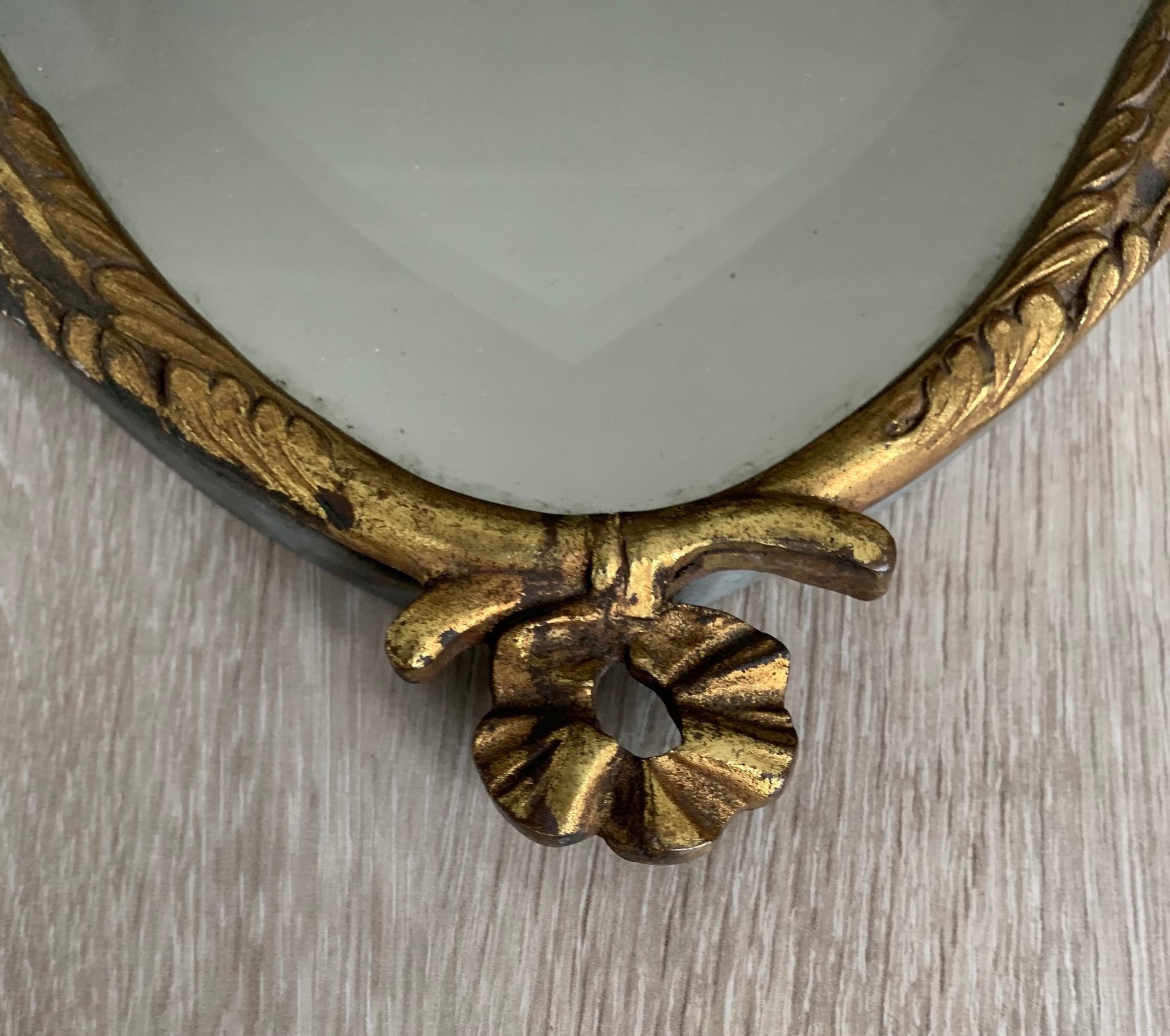 20th Century Beautiful & Beveled Wall Mirror in Gilt Bronze Frame w. Eternal Flame Torchères For Sale