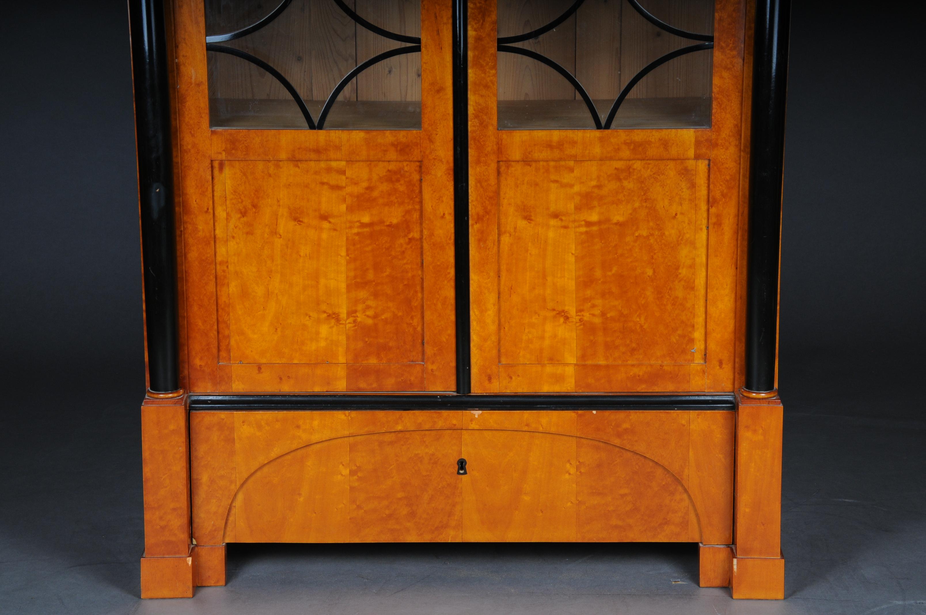 Beautiful Biedermeier showcase or bookcase, 20th century, cherrywood

Cherrywood veneer on solid softwood. Rectangular two-door corpus on block feet with partially framed transom glazing. Architecturally structured front with flanking and ebonized