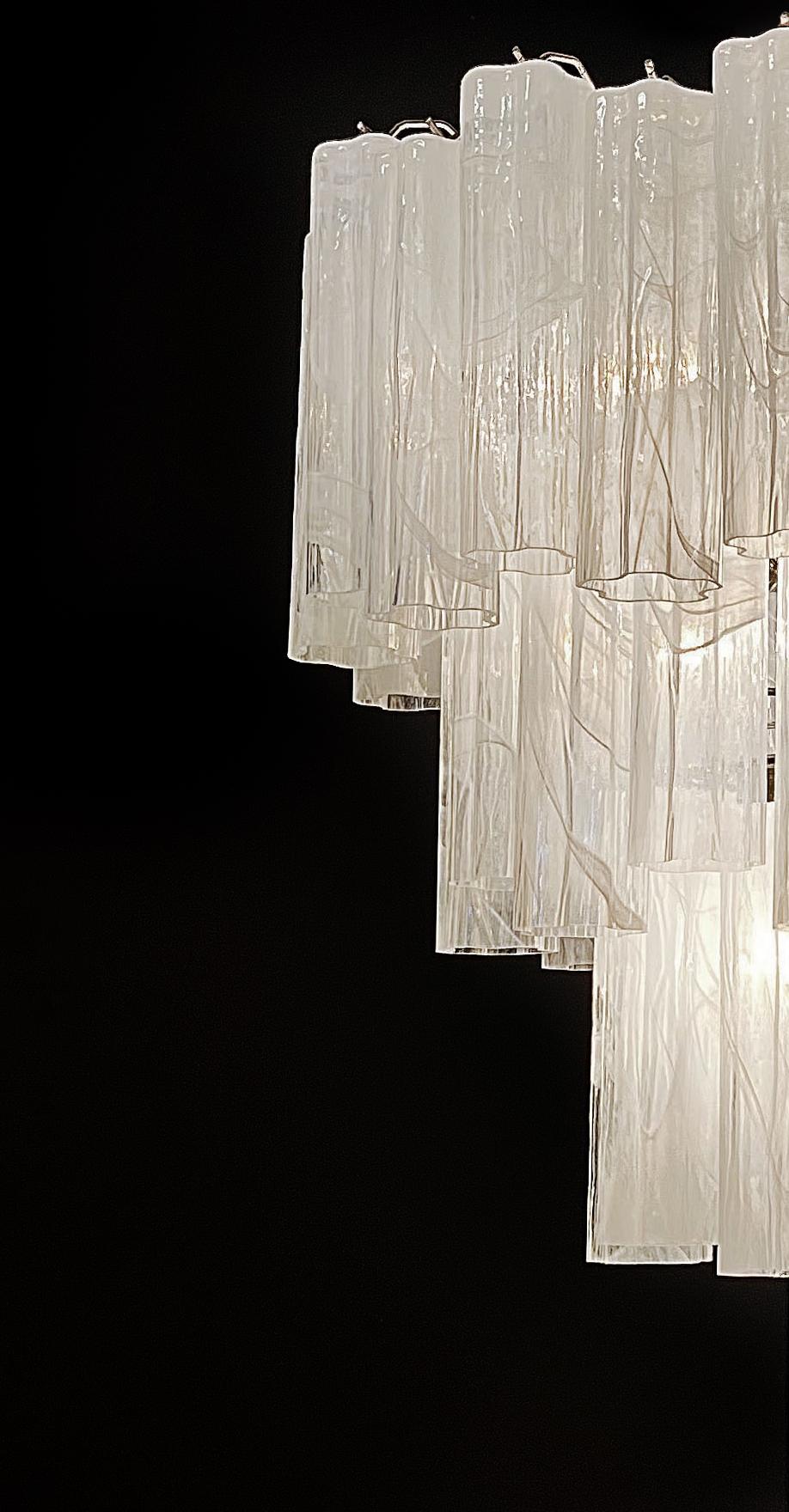 Italian vintage chandelier in Murano glass and nickel-plated metal structure. The armor polished nickel supports 48 large glass tubes in a star shape. The alabaster technique created in Venetian glassworks gives the glass an elegant grain.
Period: