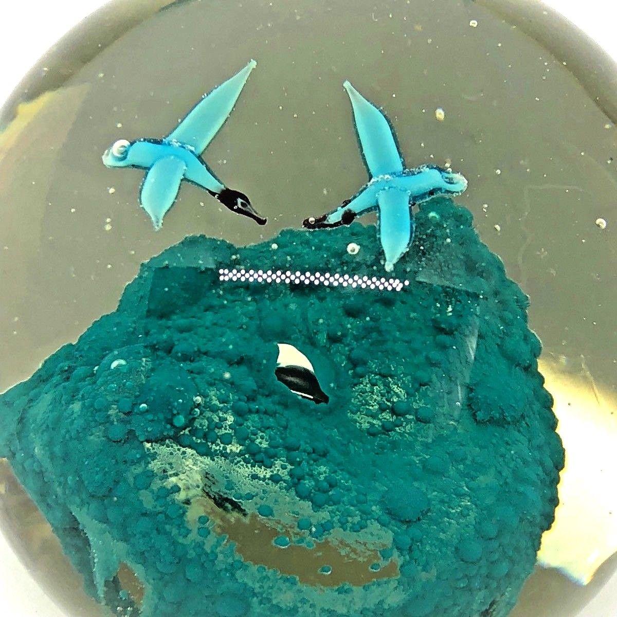 Beautiful Murano hand blown Italian art glass paper weight. Showing two birds flying over a rock inside, in different colors, floating on controlled bubbles. Colors are a blue, petrol and black. A beautiful nice addition to your desktop.
