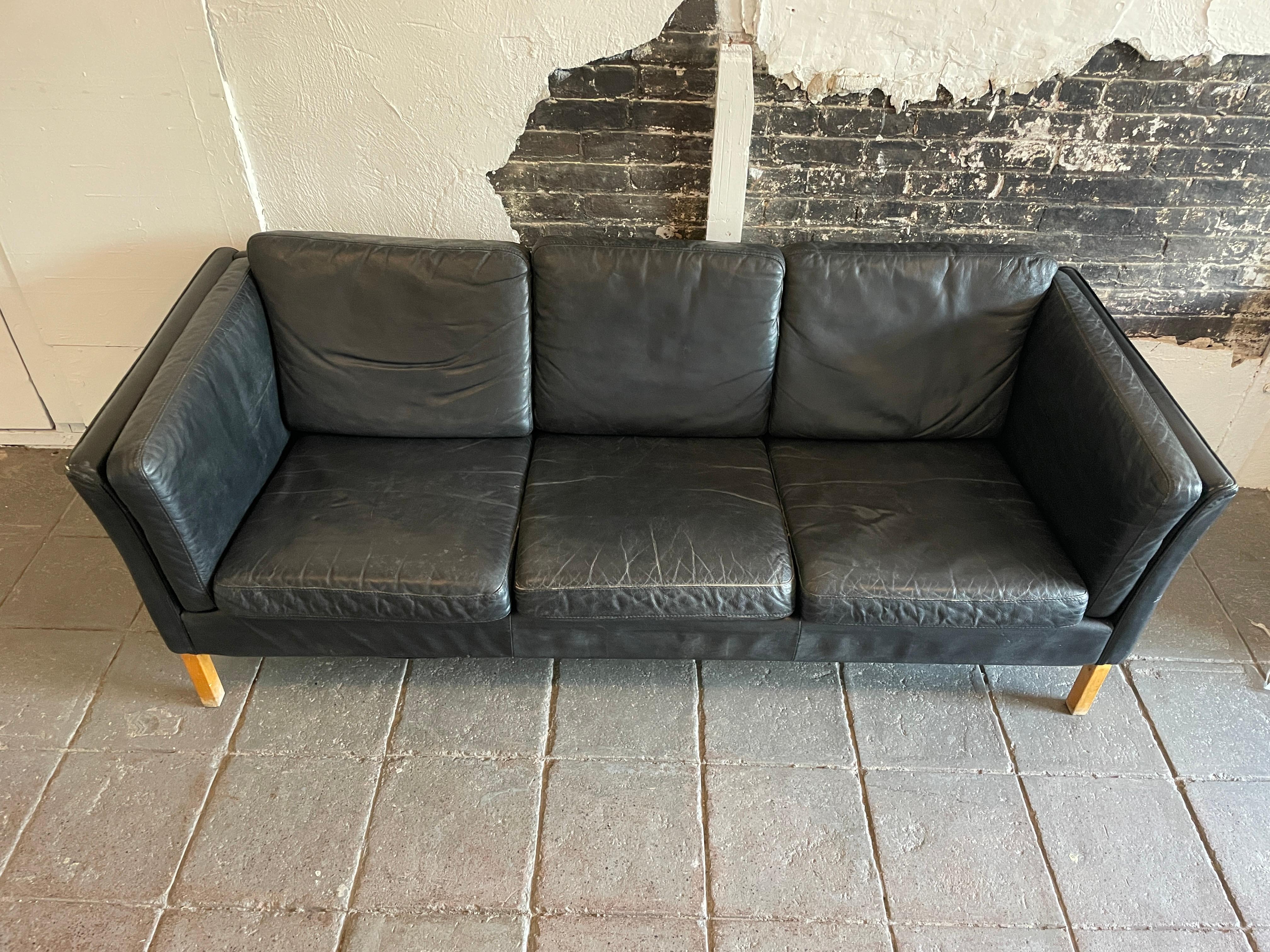 Beautiful black Leather low 3 seat Swedish modern couch sofa with rosewood legs. vintage black soft leather. Original black leather worn in perfectly. Original vintage used condition. All cushions are removable maple legs show little wear. no labels