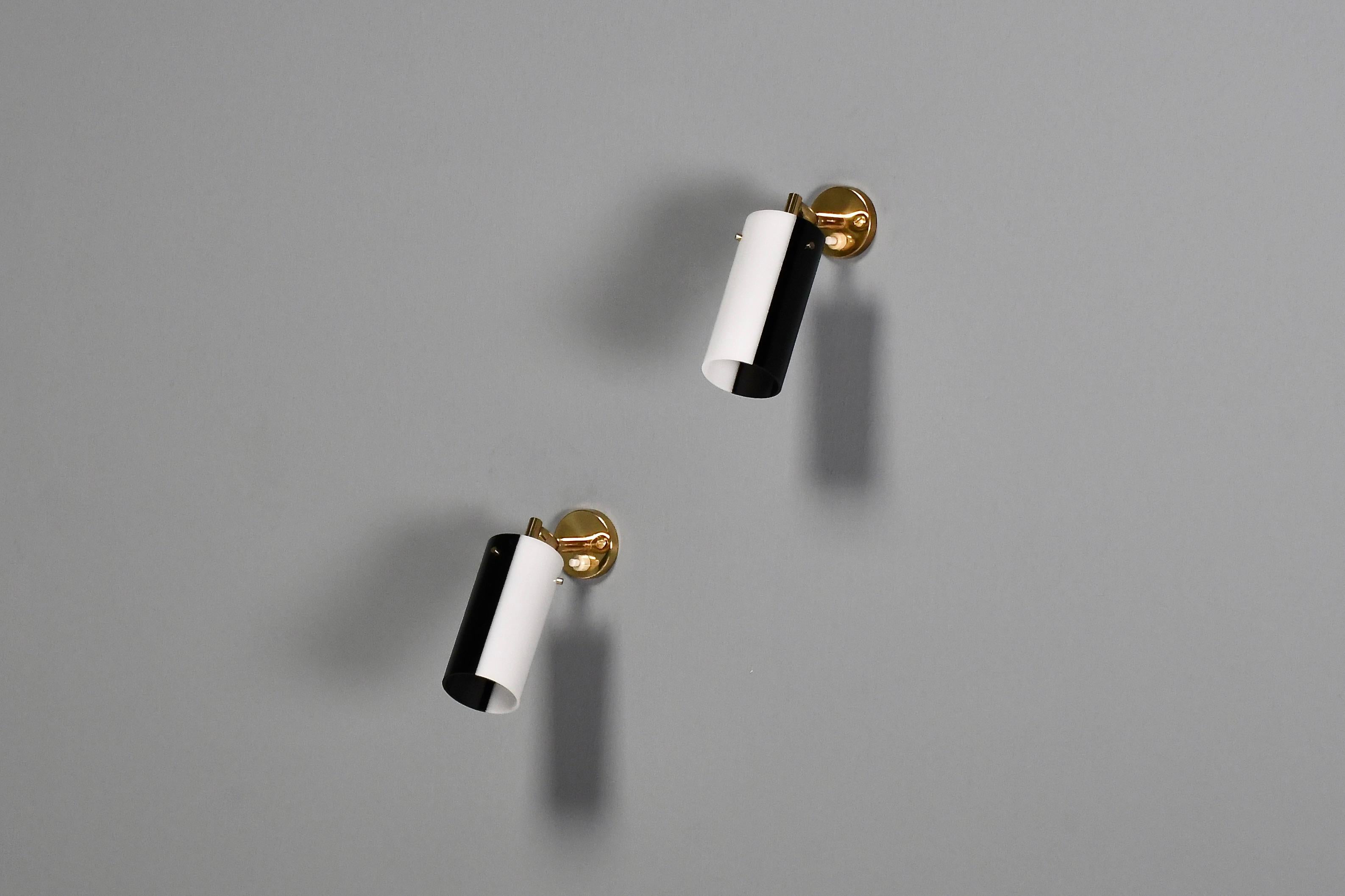 Beautiful Italian sconces in very good condition.

Designed and manufactured by Stilux in the 1960s 

Three available, price per piece.

These lamps have a perspex (acrylic) shade in black and white, the shades can rotate allowing you to customize