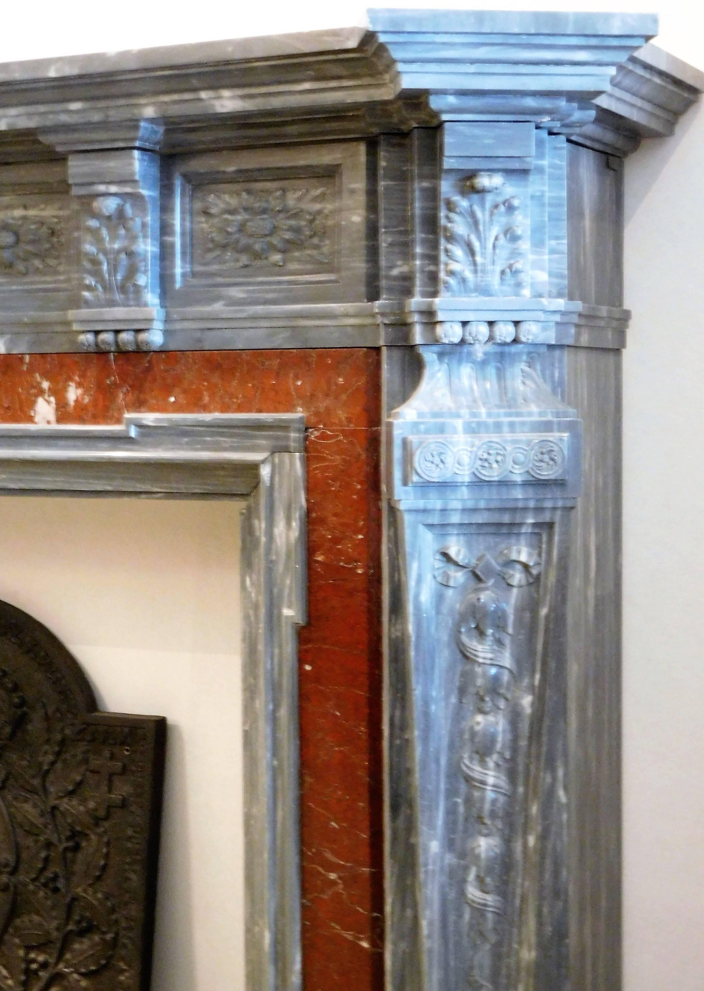 Beautiful Bleu Turquin-marble fireplace from Antwerp, Belgium. The inlay of Brèche Sanguine-marble gives to this fireplace allure and elegance. The pilaster-shaped jambs are adorned with fine carvings and six Acanthus-carved consoles, supporting the