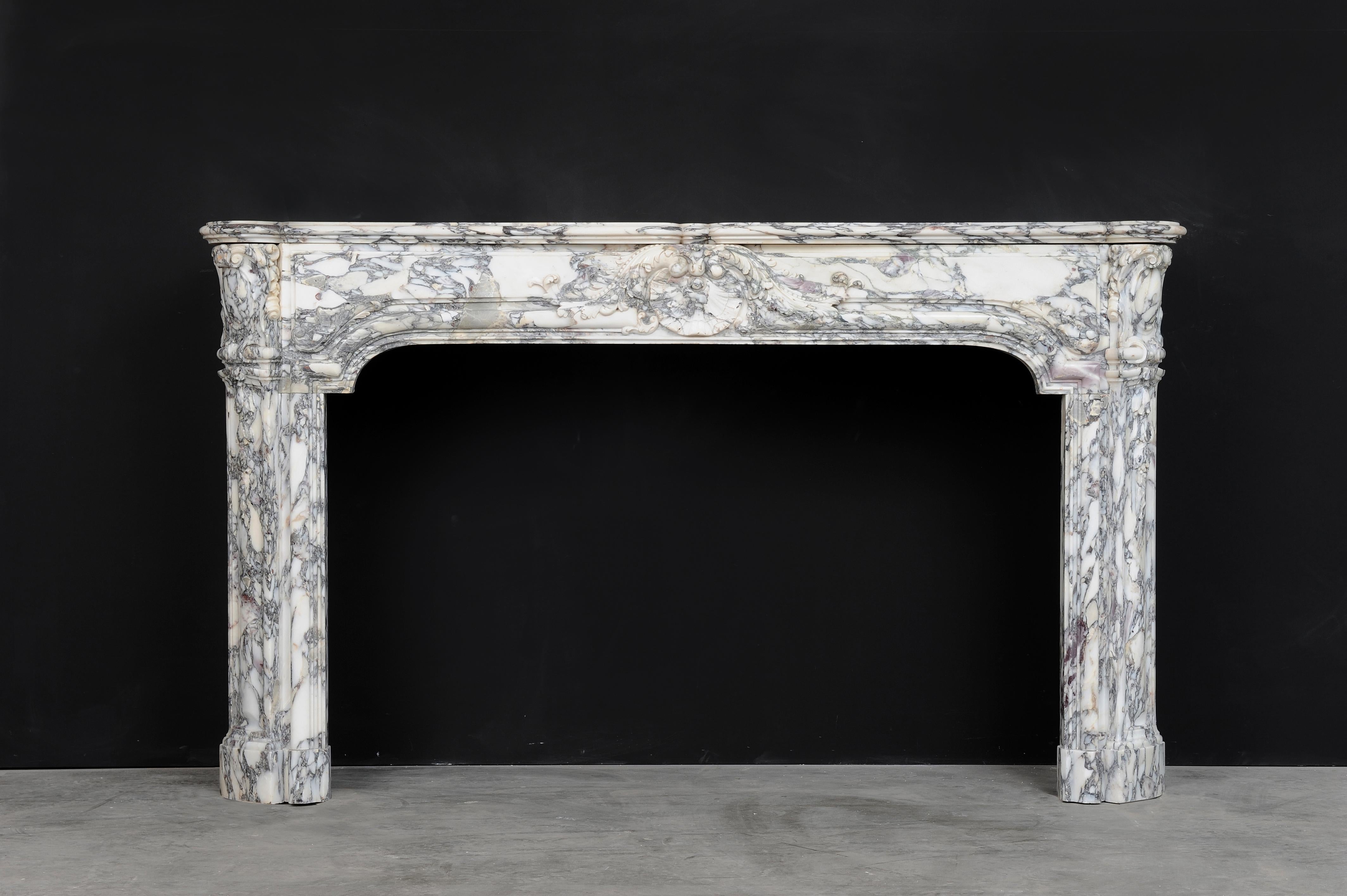 Its a pleasure to offer this wonderful French fireplace in beautiful Italian Breche (Breccia) marble.
This early 19th century transitional (XIV - XV) mantel shows a great variety of floral decorations though out.

Superb arched, paneled freeze with