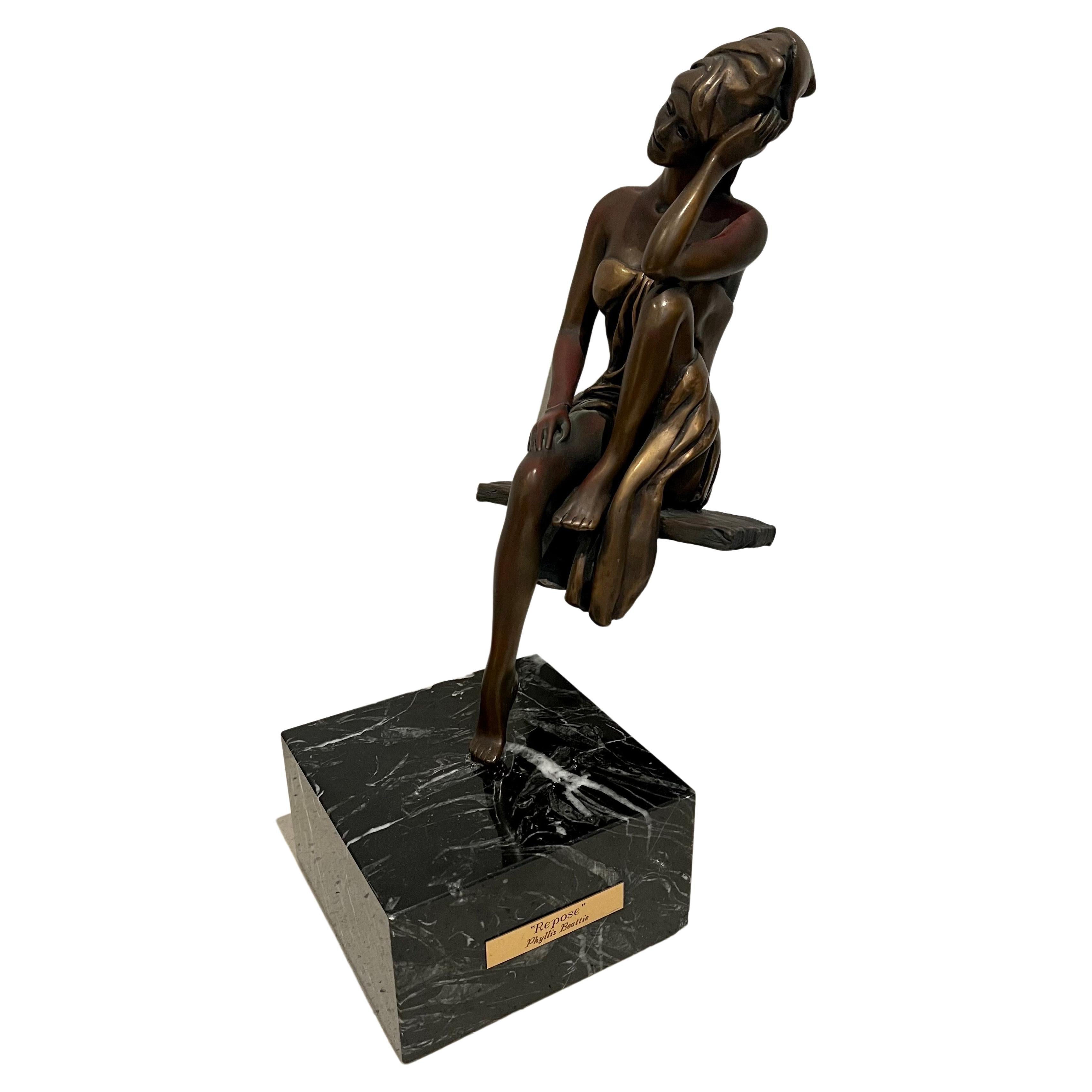 Beautiful sculpture in bronze by artist Phyllis Beattie, circa 1990's sitting on a solid black marble base, the figure pins and can be removed for easy shipping and handling.