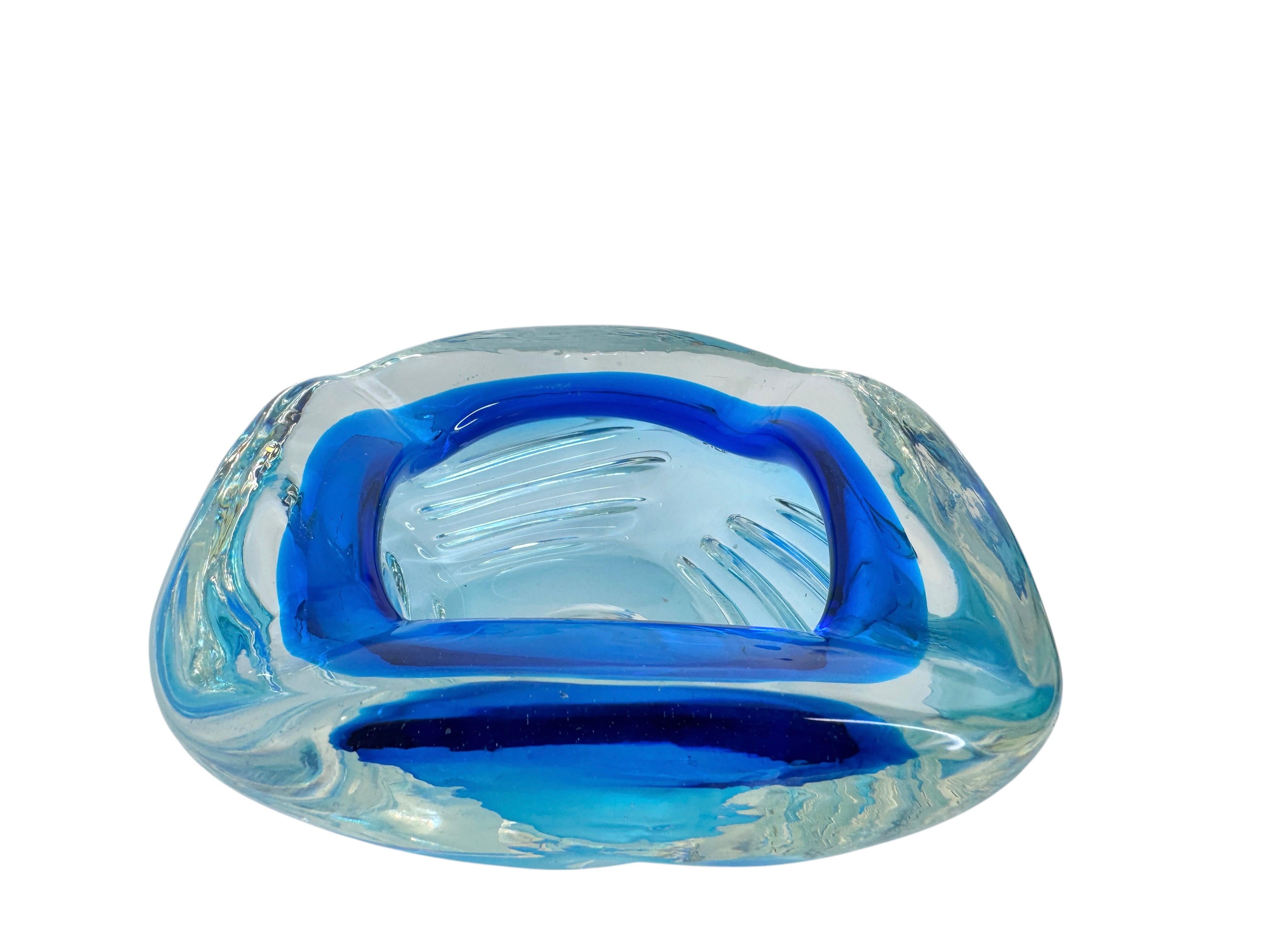 Gorgeous large heavy hand blown Murano art glass piece. A beautiful brutalist and organic ashtray, Venice, Murano, Italy, 1970s. Colors are Blue and clear glass, with controlled lines on the outside. Found at an estate sale in Modena, Italy. Nice
