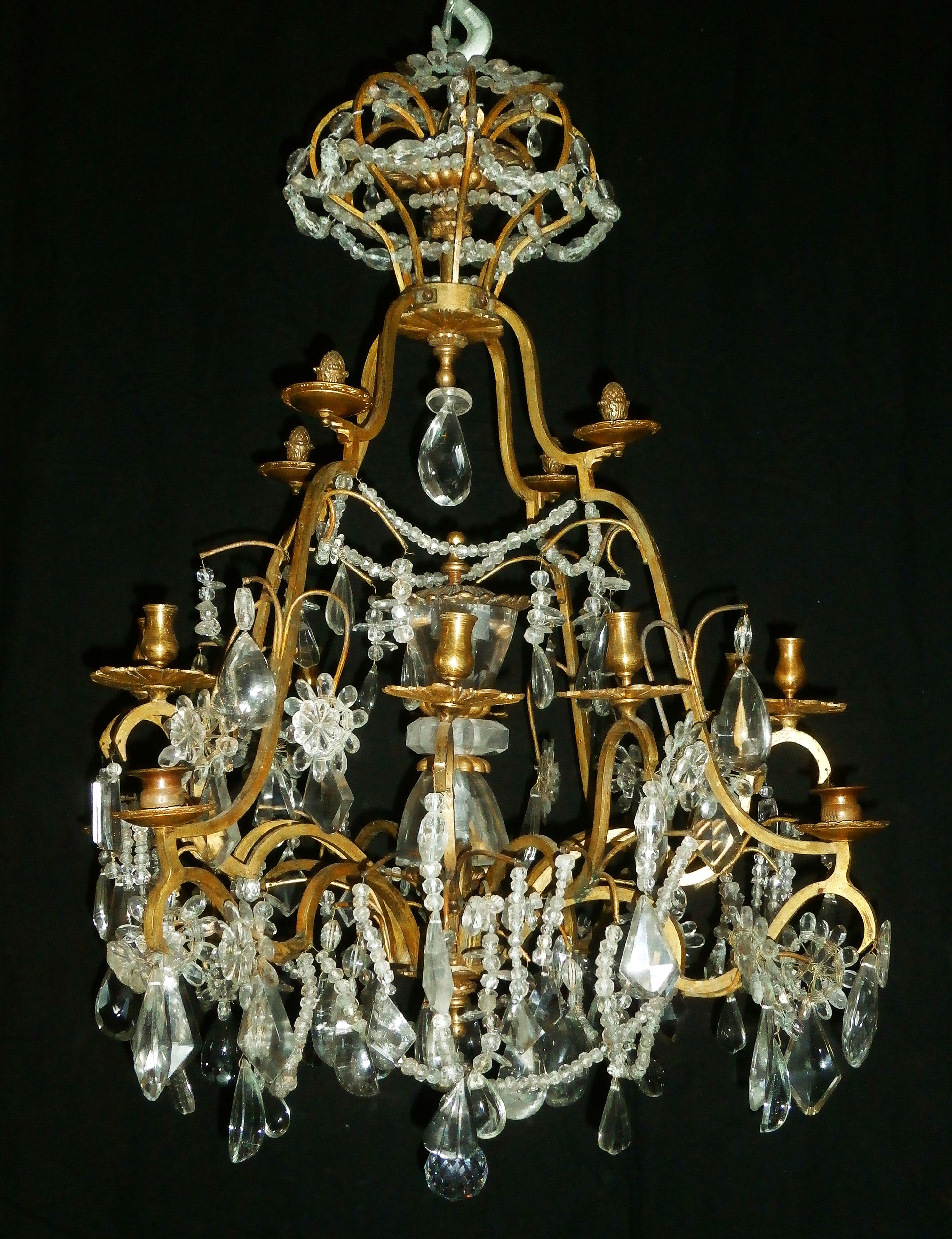 Very beautiful Louis XV style chandelier in gilt bronze with rich rockcristal decoration. The centre is decorated with a baluster entirely enclosed with rockcristal elements. It was kept since the 19th century by a family in Belgium. Parisian