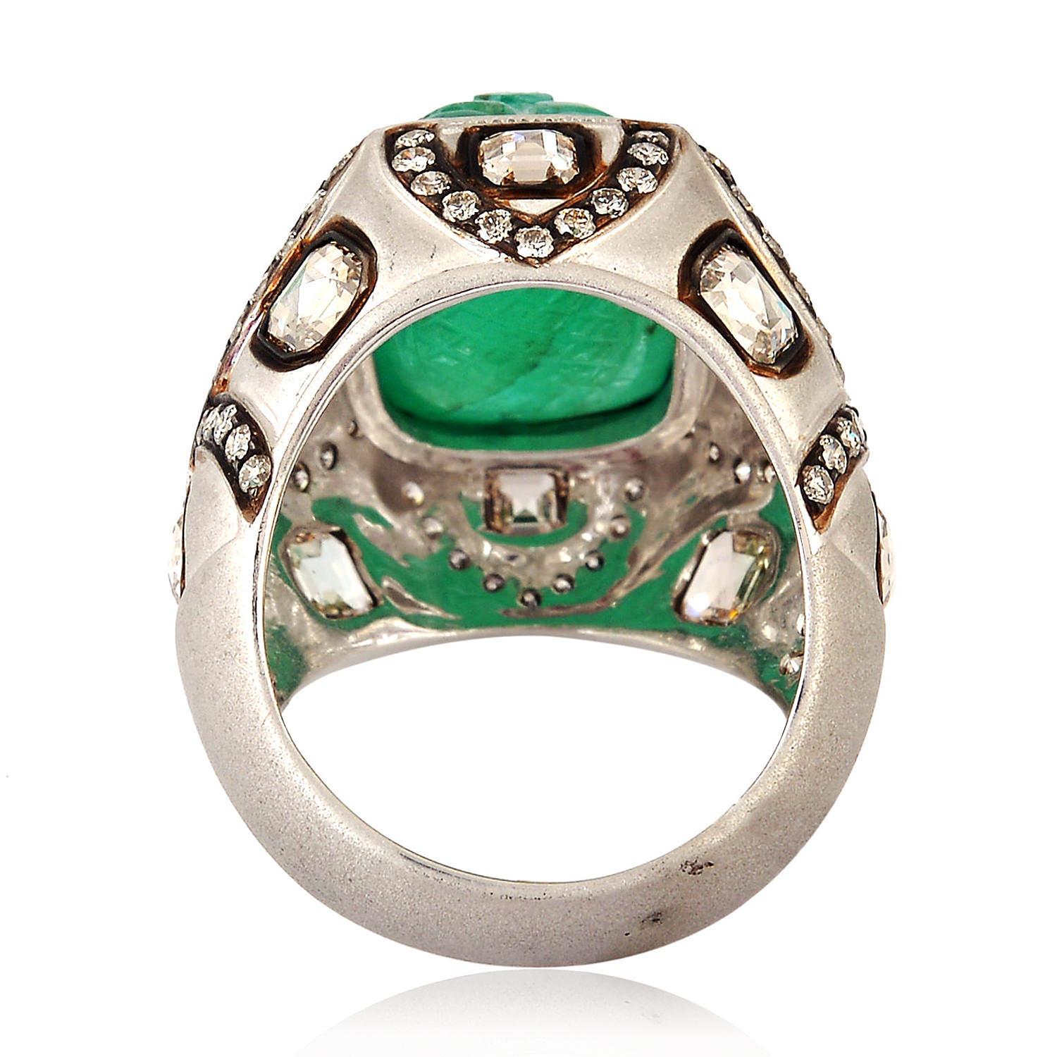 This beautiful Carved Emerald Ring with diamonds in 18k white gold is brush polished and one of our regal looking favorites. 

Ring size: 7.5 ( Can be sized )

18k:15.258g
Diamond: 2.96ct
Emerald: 11.85ct
