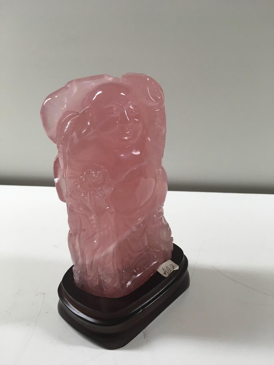 A beautiful sculpture in rose quartz with wooden base produced in China. Italian private collection. Weight 1.550 Kg.